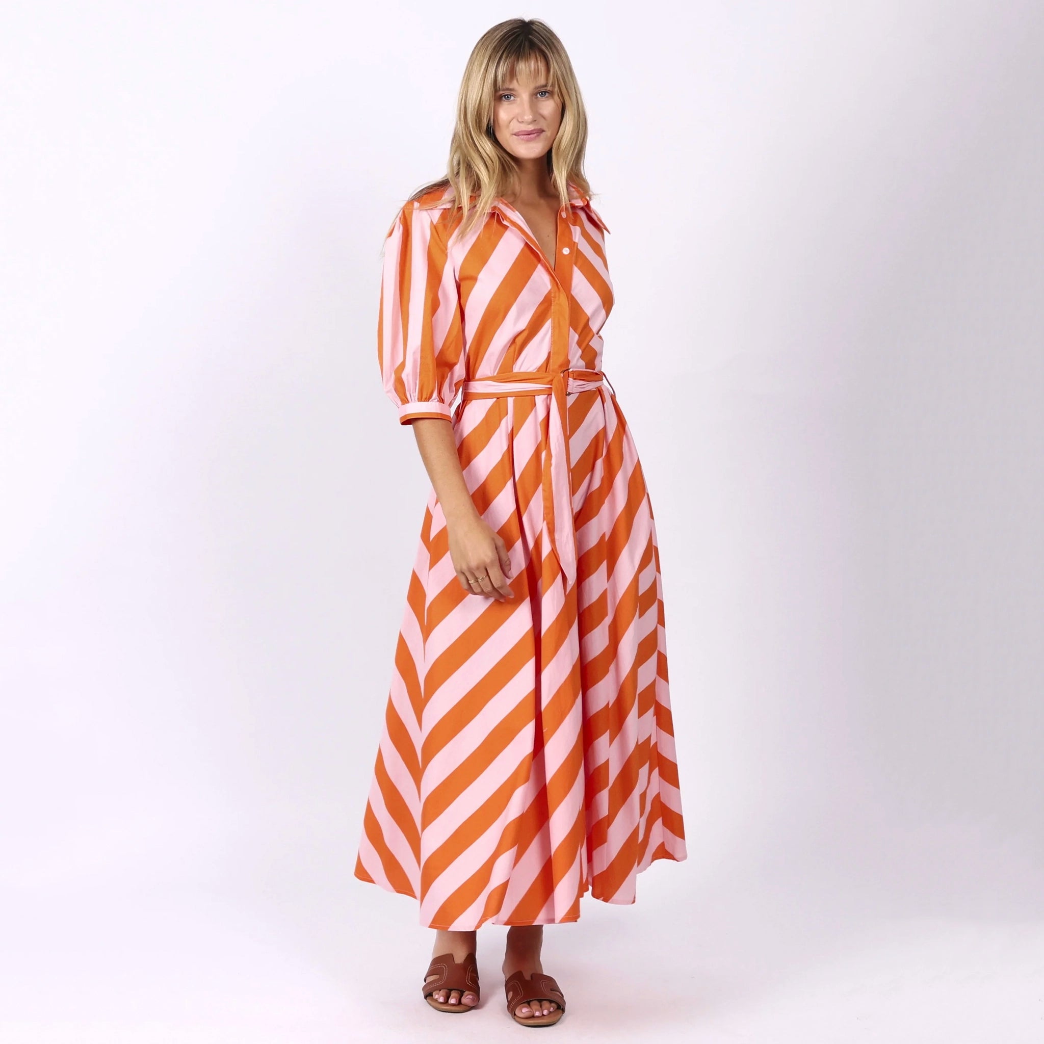 Woman wearing a red and white striped dress on a white background