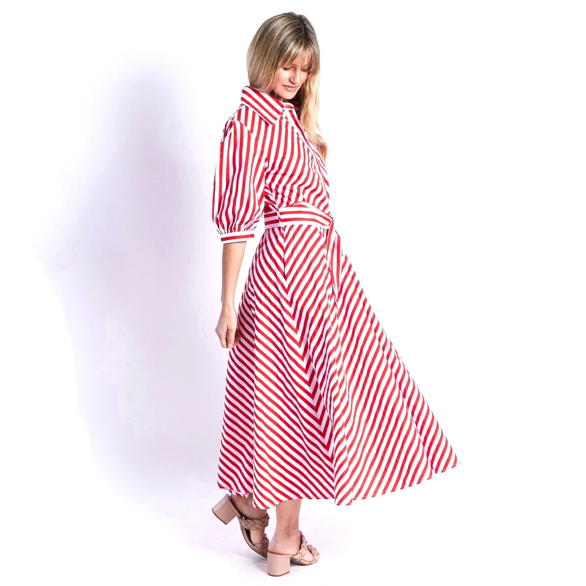 Woman wearing a red and white striped dress on a white background
