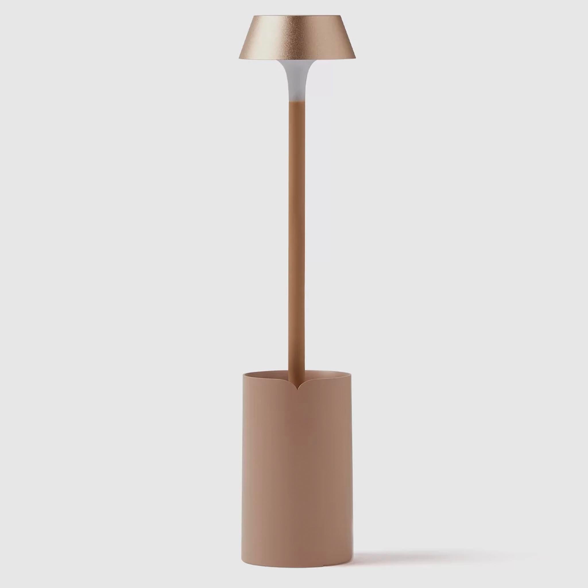 Modern clip on lamp with a cylindrical base and metallic shade on a white background