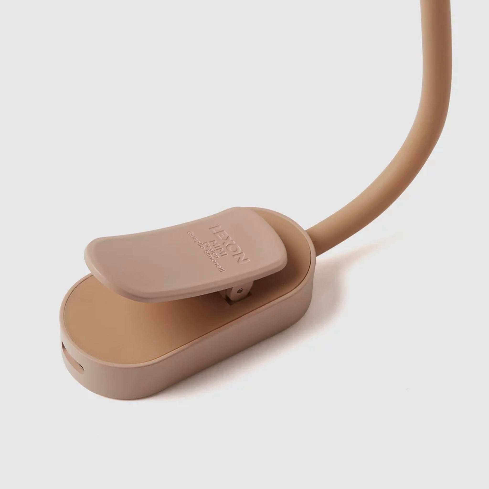 Beige lamp with a flexible neck on a light gray background