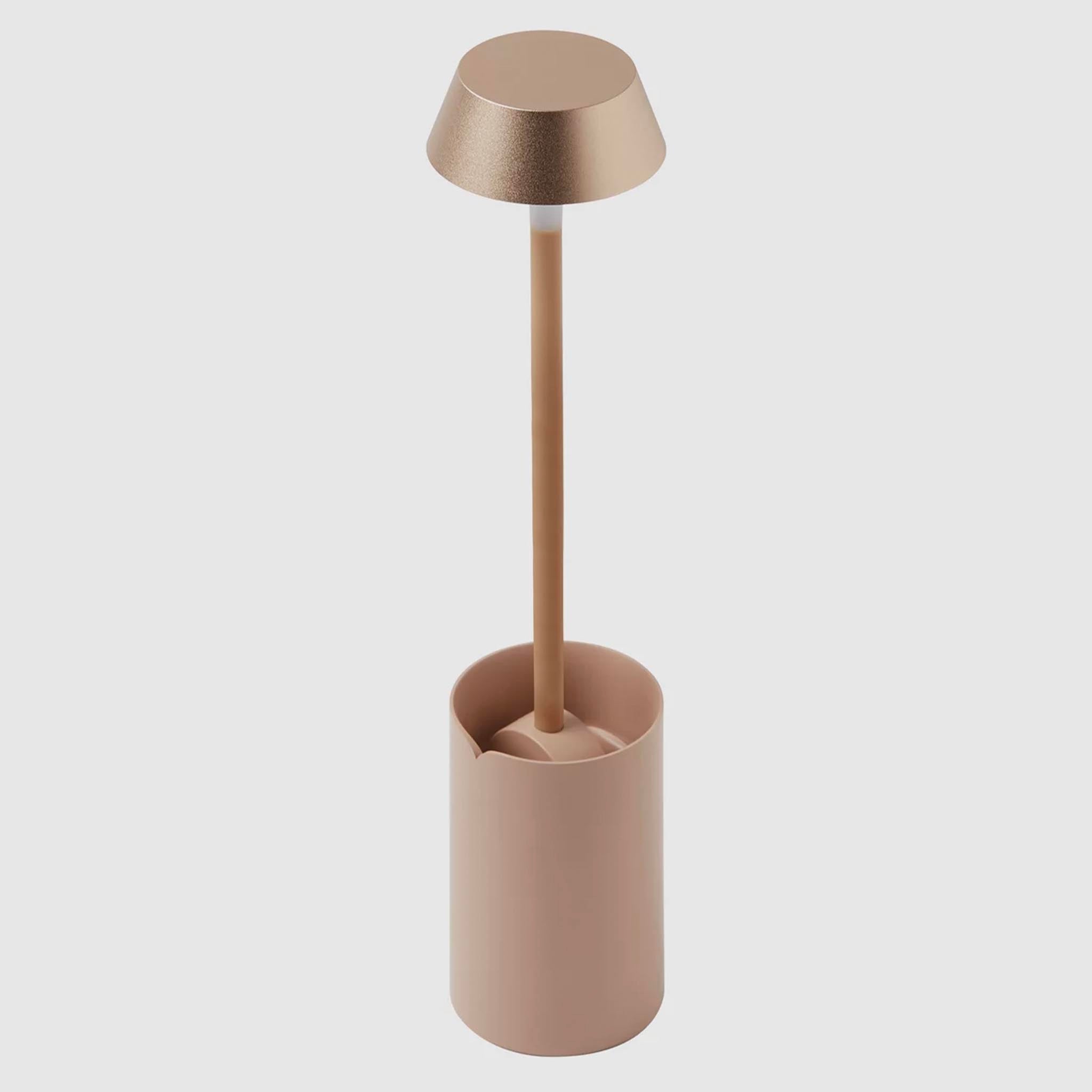 Modern clip on lamp with a cylindrical base and metallic shade on a white background