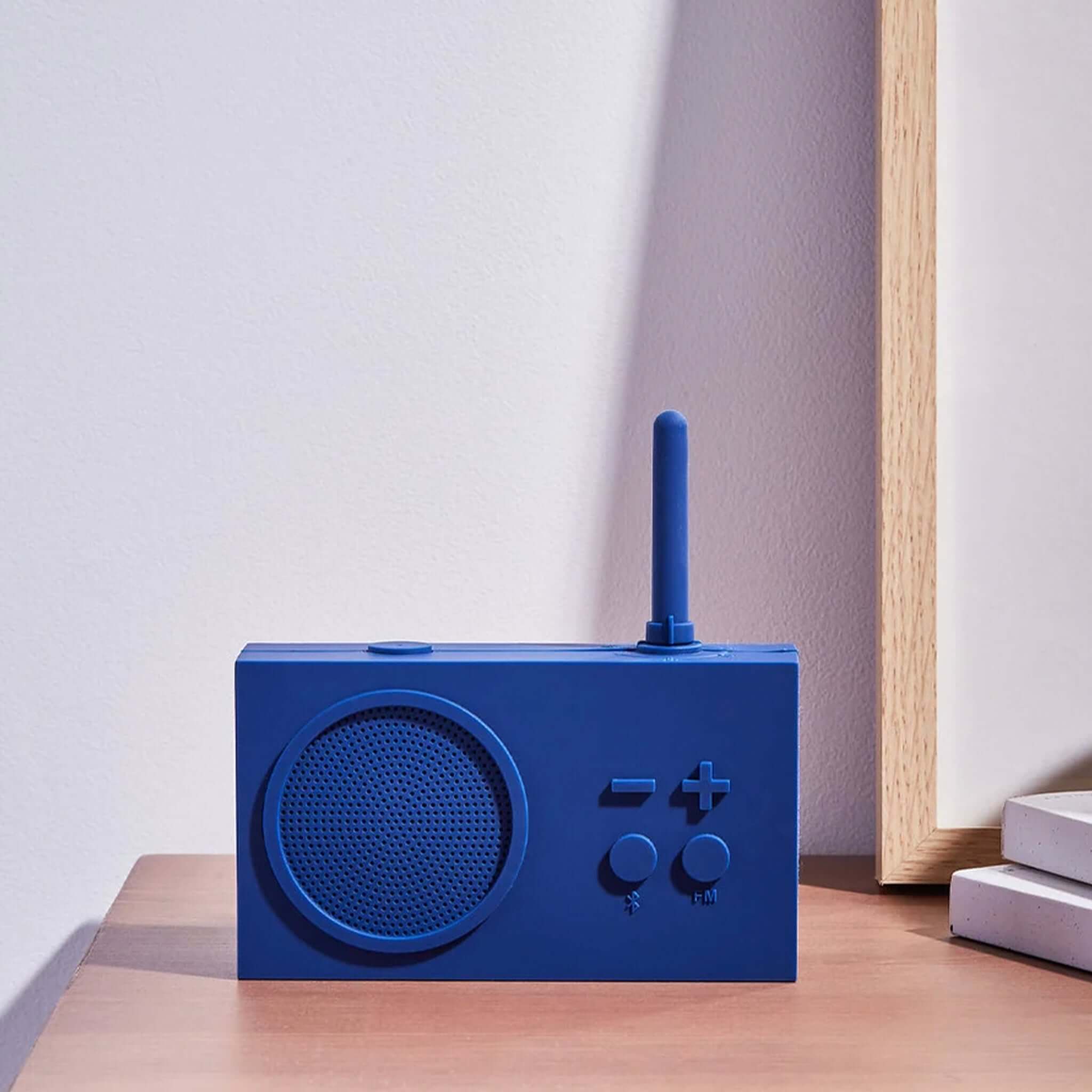 Lexon TYKHO 3 FM Radio & Bluetooth Speaker - Dark Blue on a wooden table with minimalist decor.