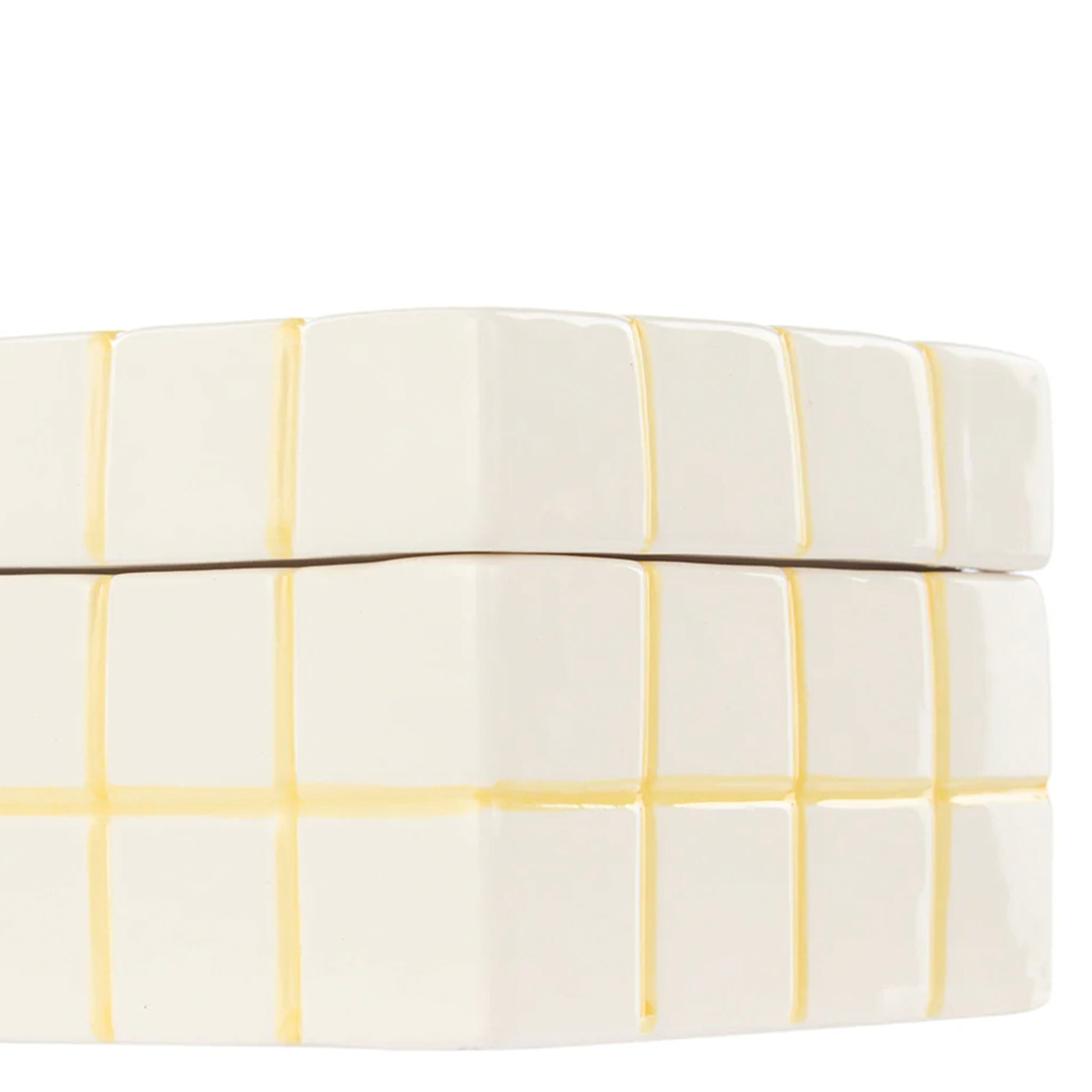 White ceramic box with yellow grid pattern on a white background