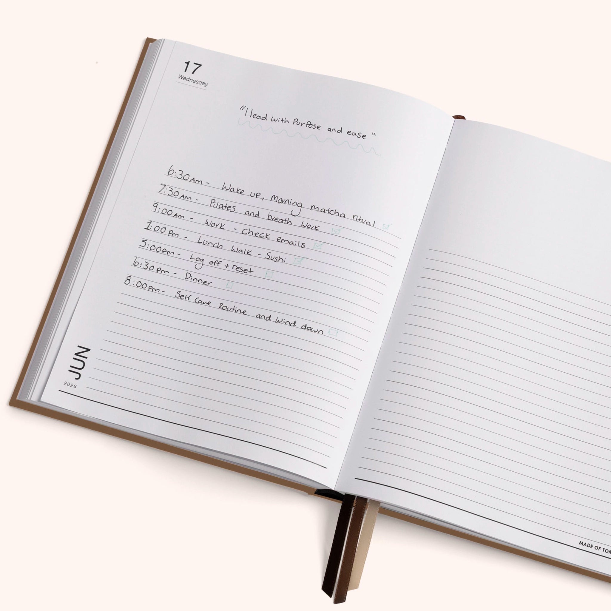 Open planner with handwritten schedule on a white background