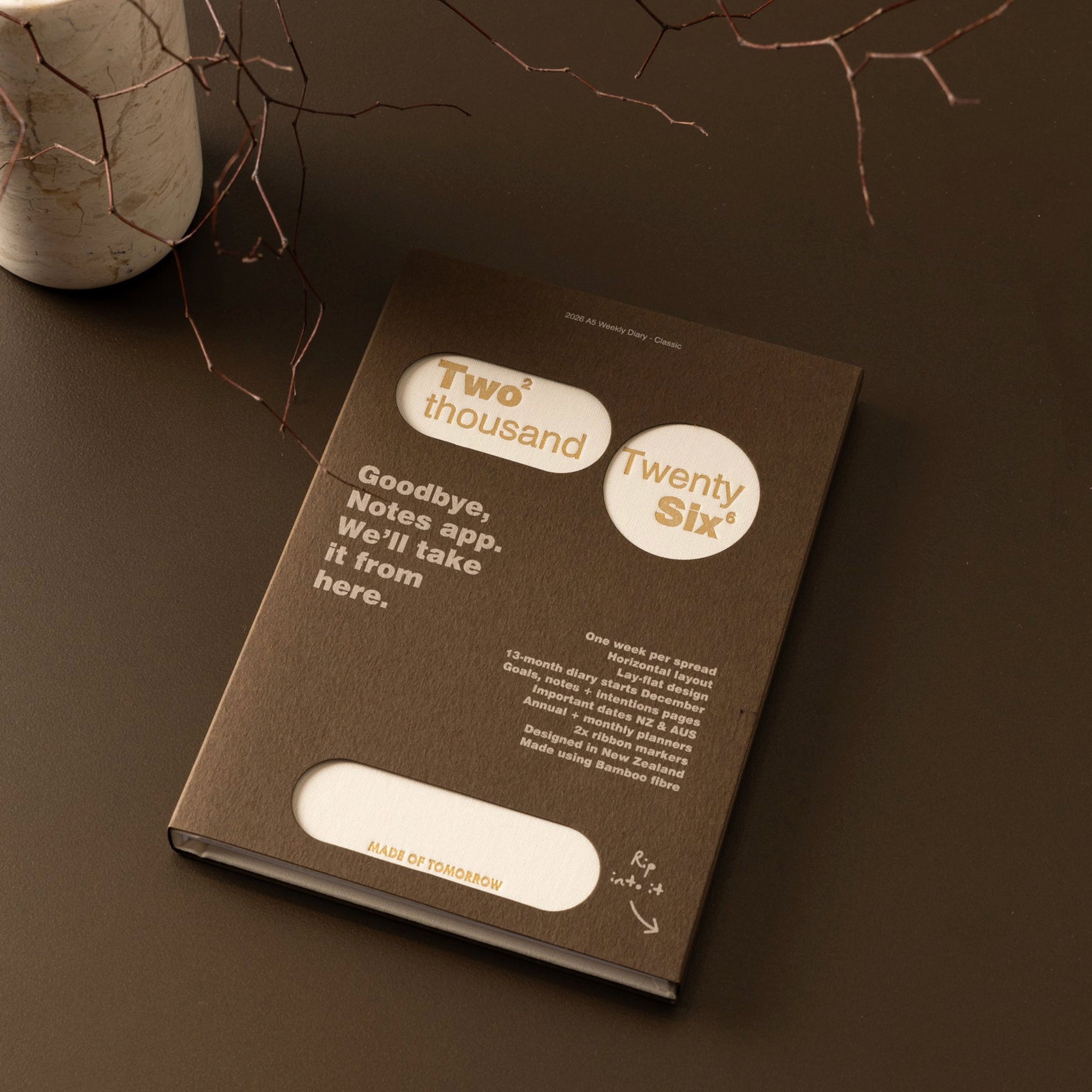 Brown notebook with text on a dark surface