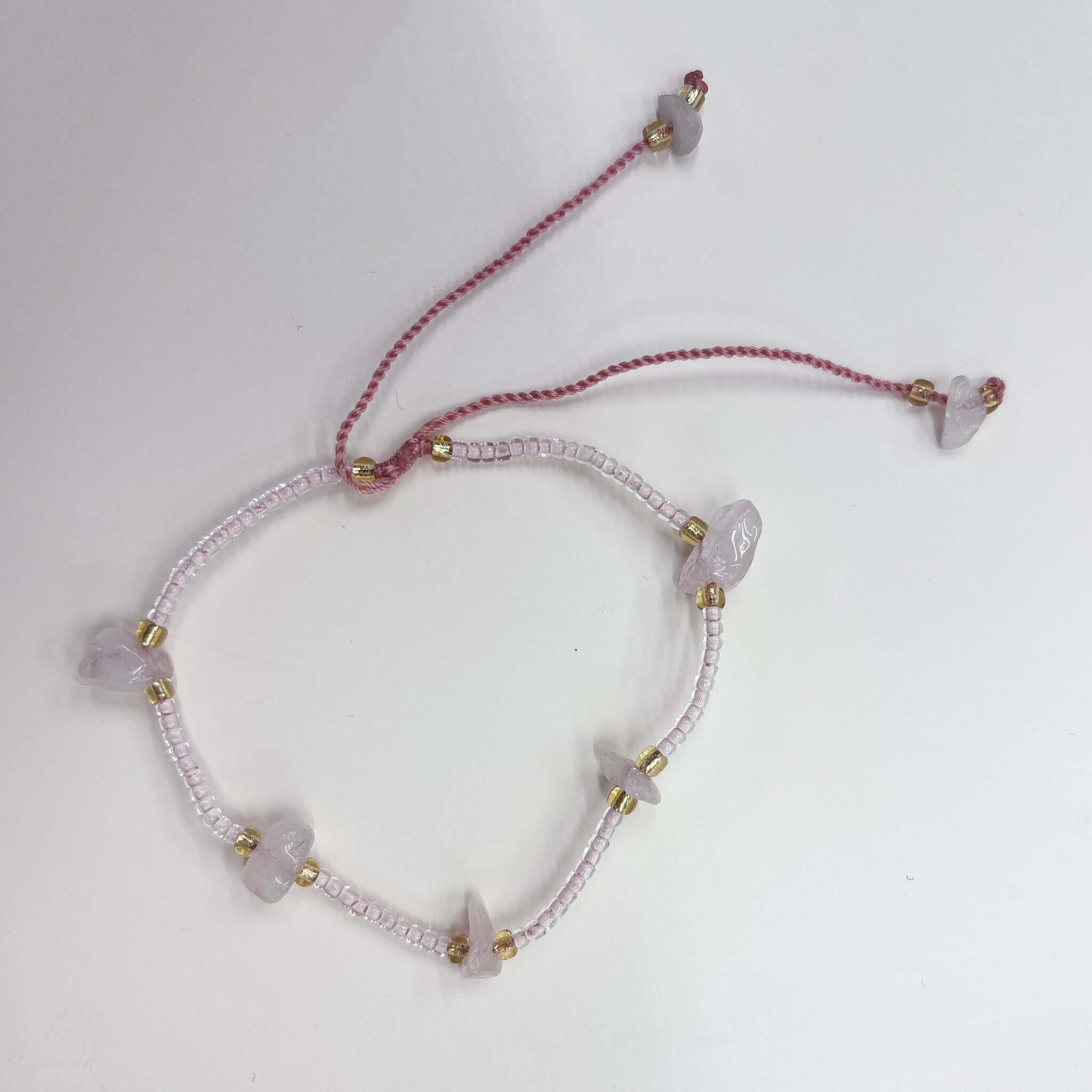 Margaret Cora Bracelet featuring pale seed beads and raw crystal chip accents with gold spacers.