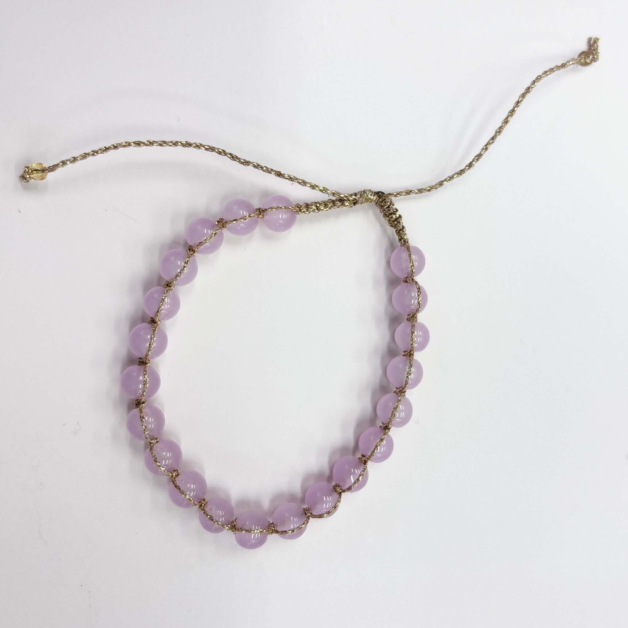 Margaret Edna Bracelet featuring chunky beads in soft lilac on fine gold cord with adjustable sliding closure.