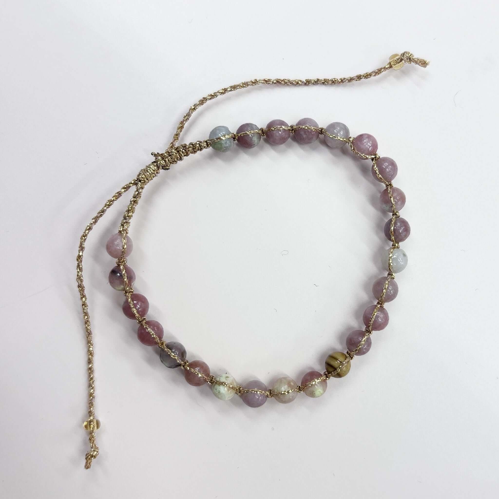 Margaret Ellen Bracelet featuring smooth stone beads in delicate gold thread, perfect for stacking.