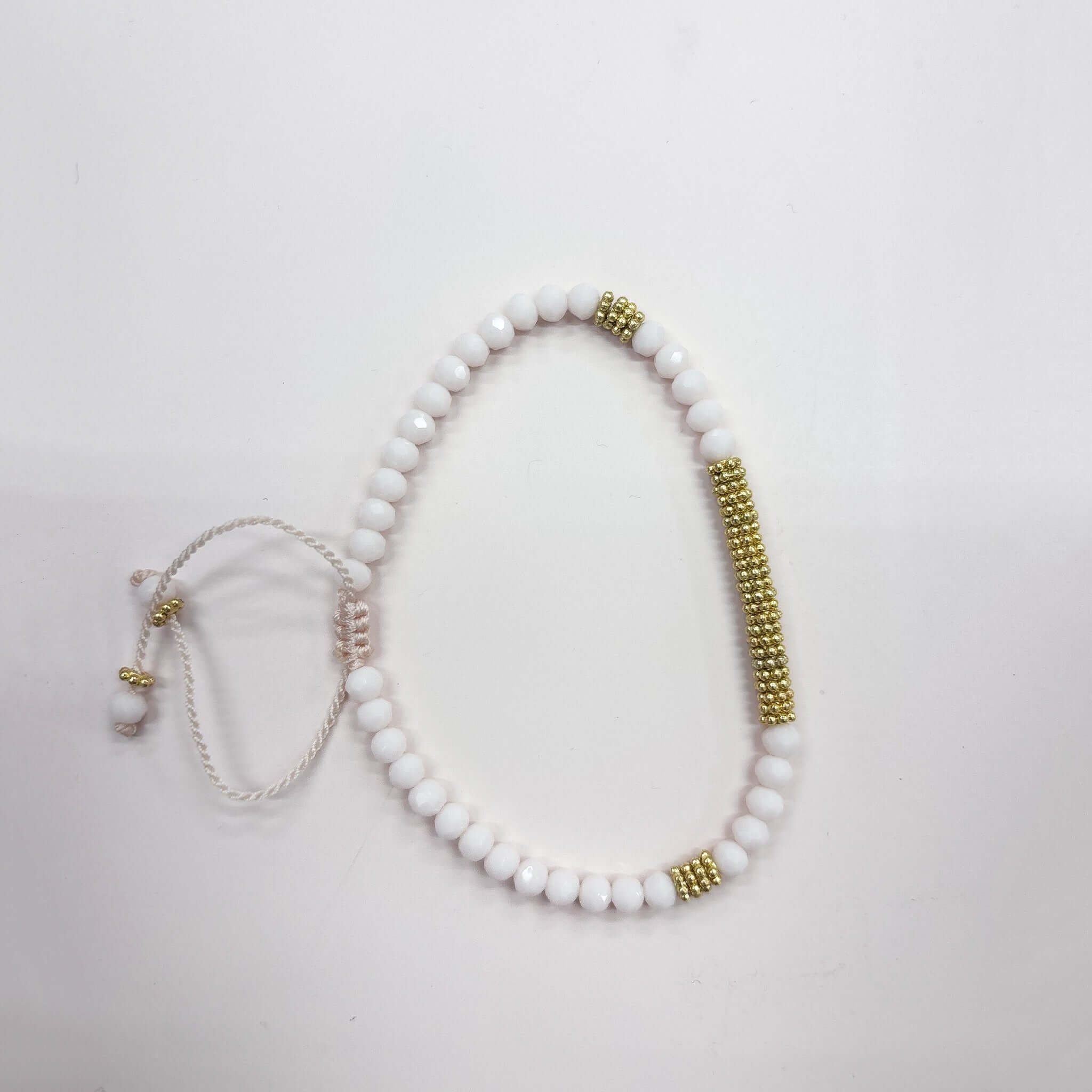 Stylish Margaret Lola Bracelet featuring crystal beads and a woven gold bead bar centerpiece.