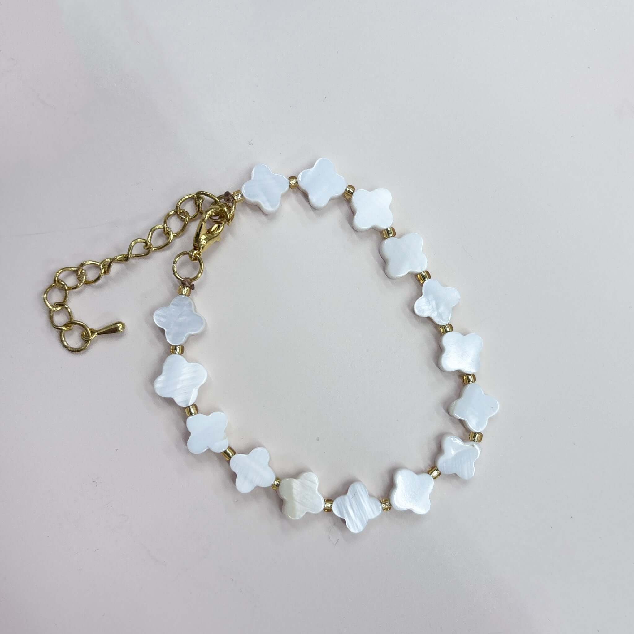 Margaret Shell Bracelet featuring mother-of-pearl clover-shaped beads and gold spacers, ideal for any outfit.