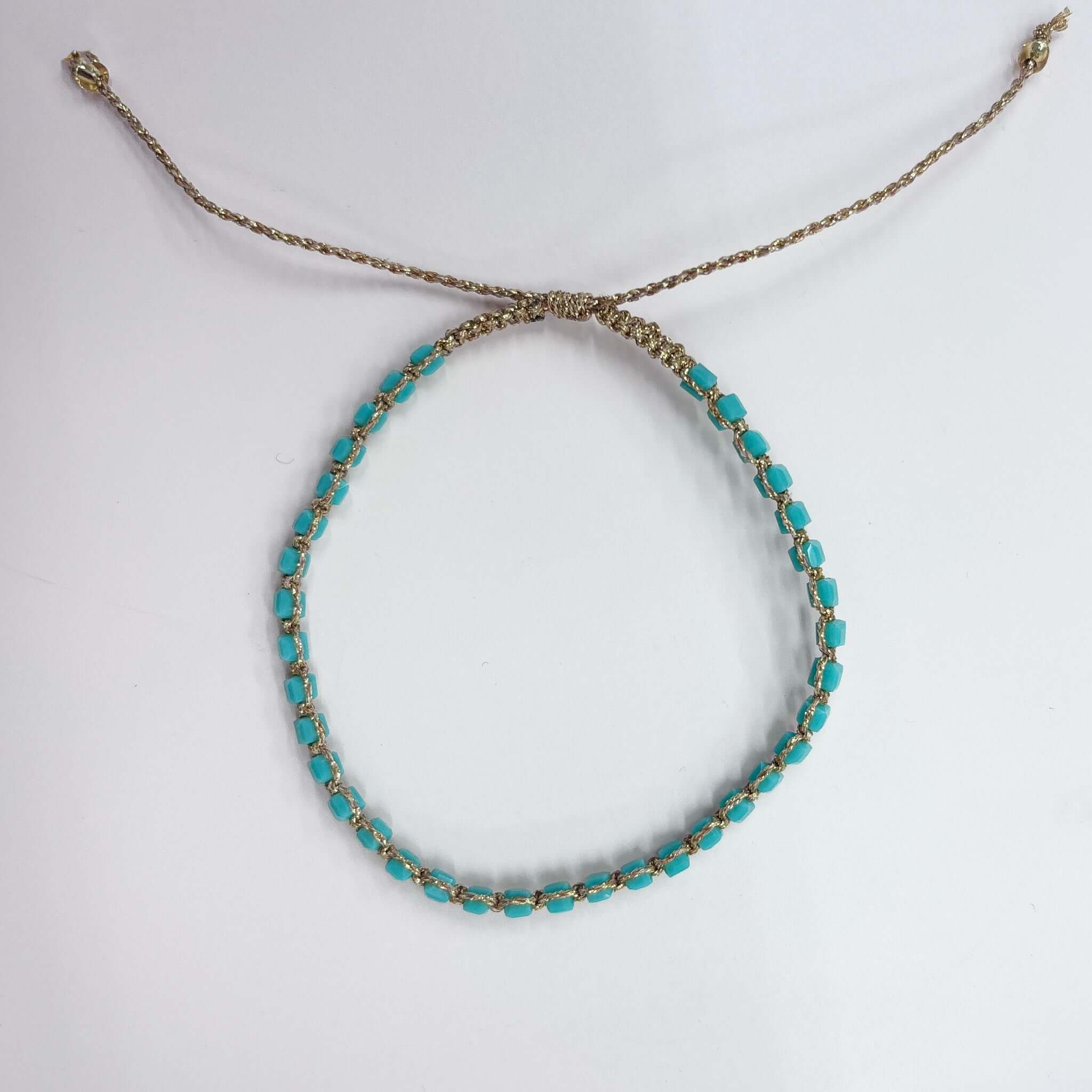 Turquoise Margaret Adeline Bracelet with gold thread cord and adjustable closure.