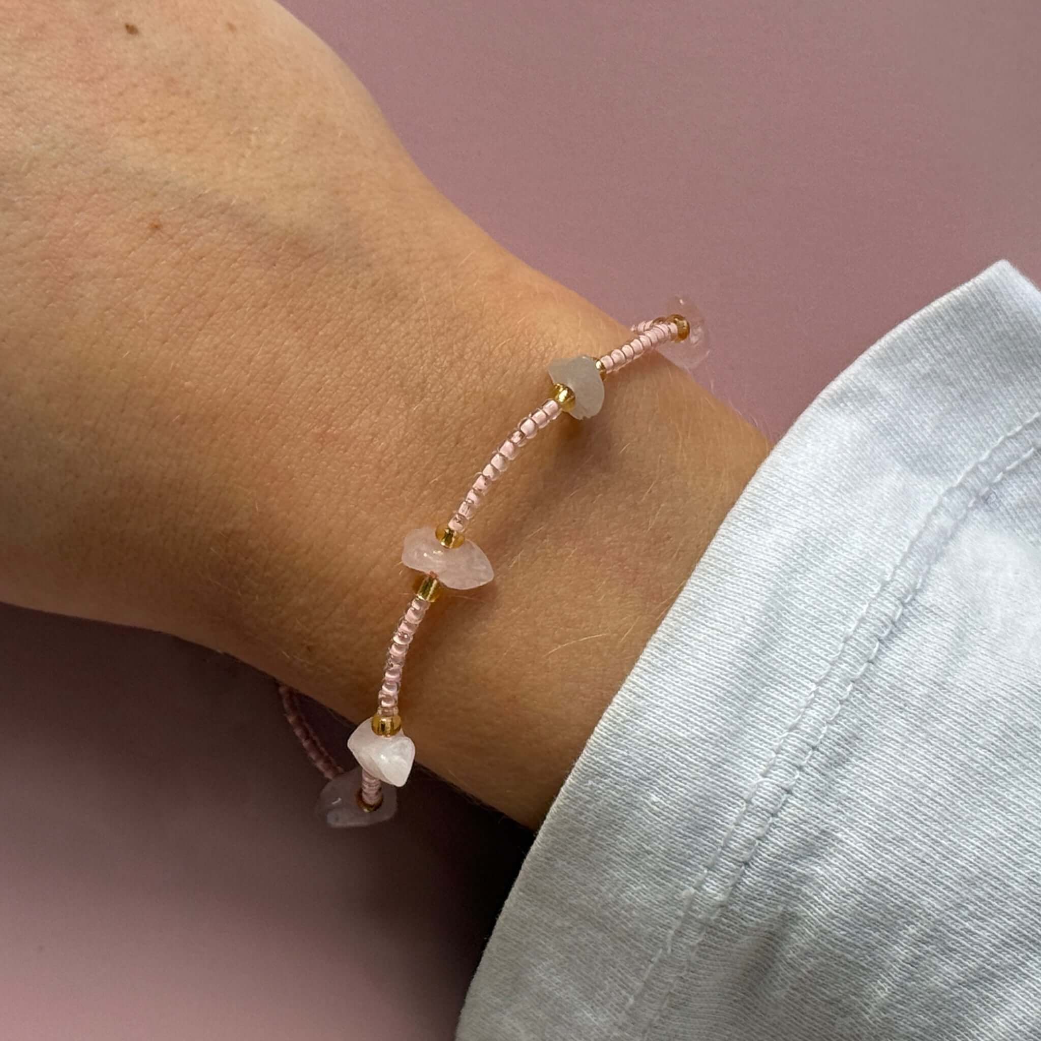 Margaret Cora Bracelet featuring pink seed beads and raw crystal chips on a delicate wrist.