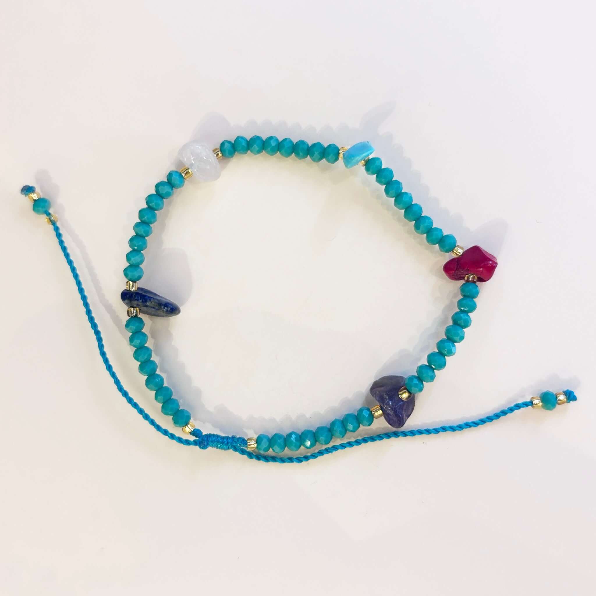 Margaret Cora Bracelet featuring turquoise seed beads and raw crystal chip accents on an adjustable cord.
