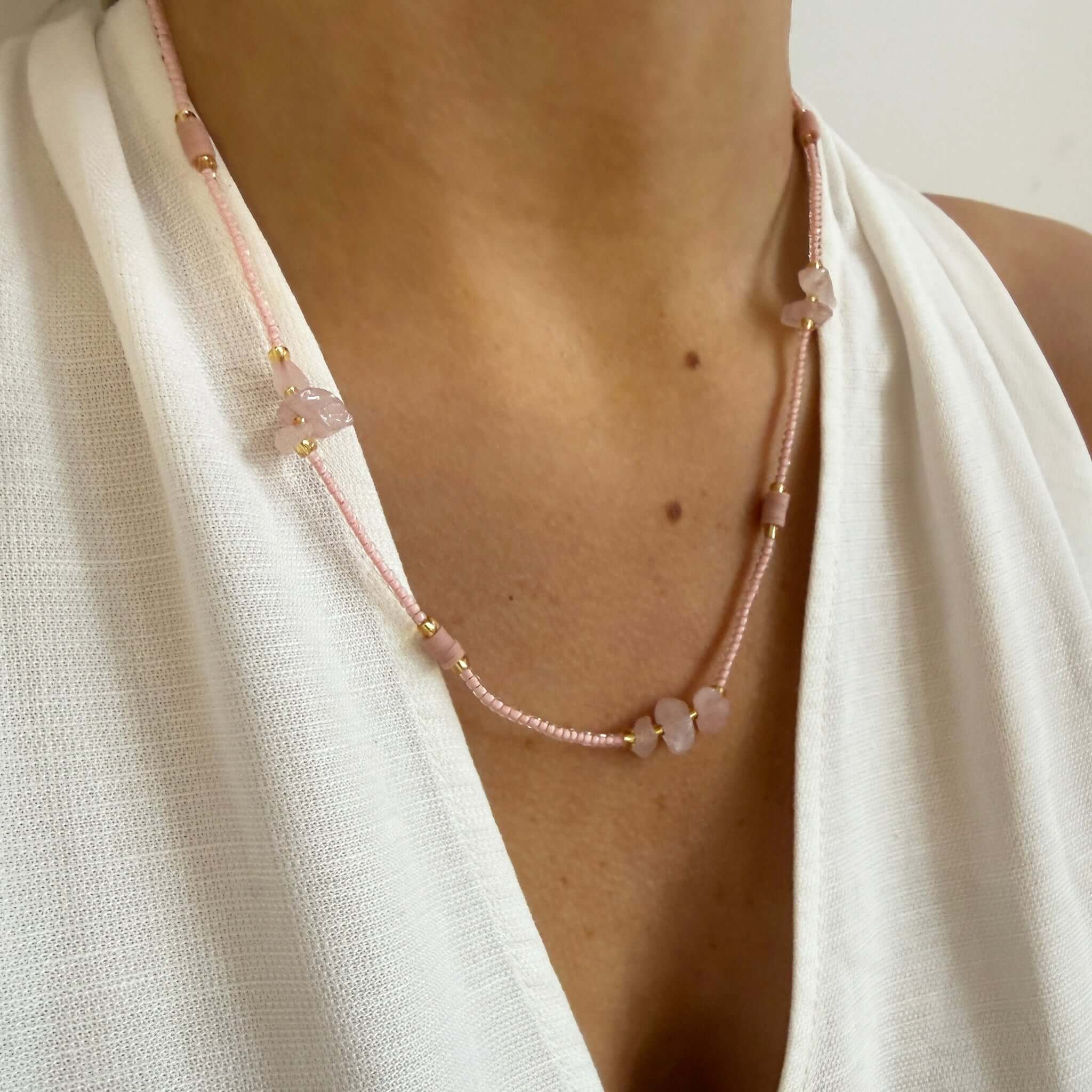 Margaret Cora Necklace featuring pink seed beads and raw stone accents with gold spacers.