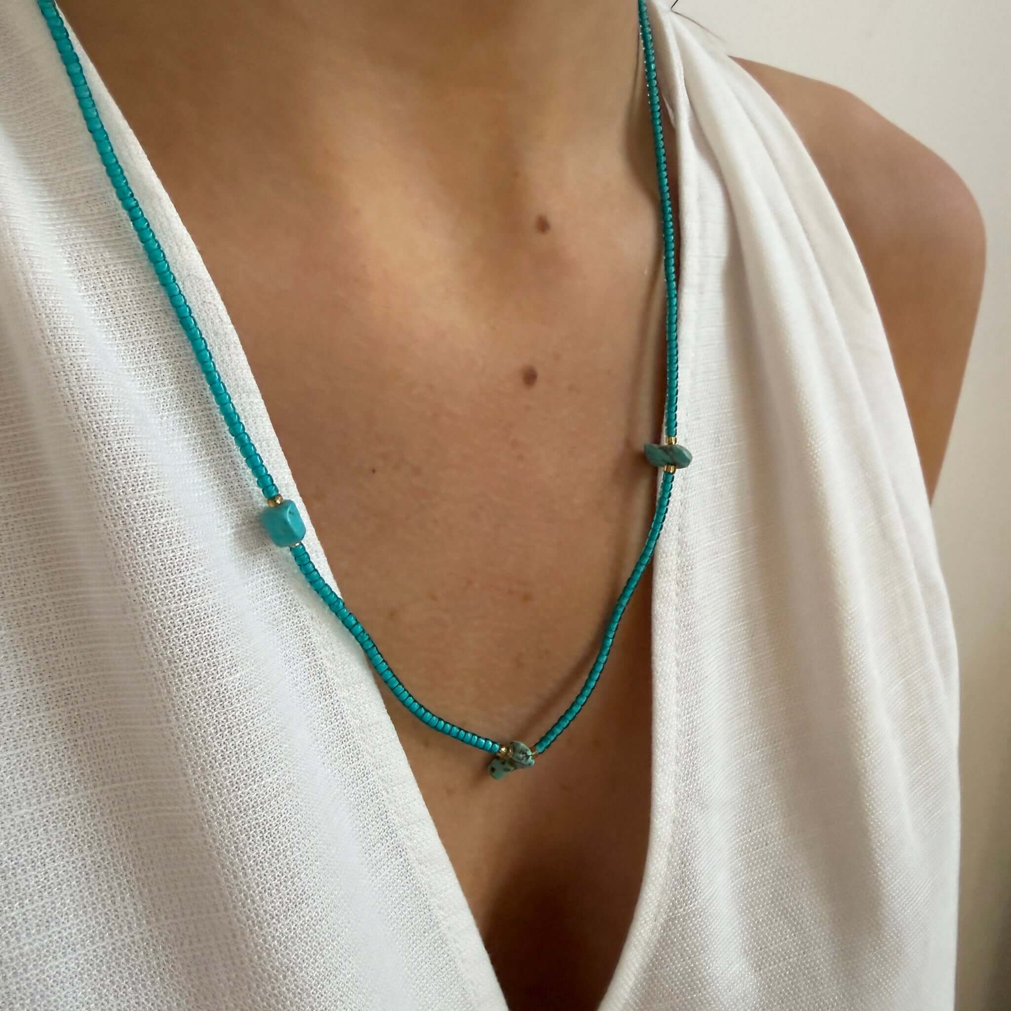 Margaret Cora Necklace featuring vibrant seed beads and raw stone accents on a model's neckline.