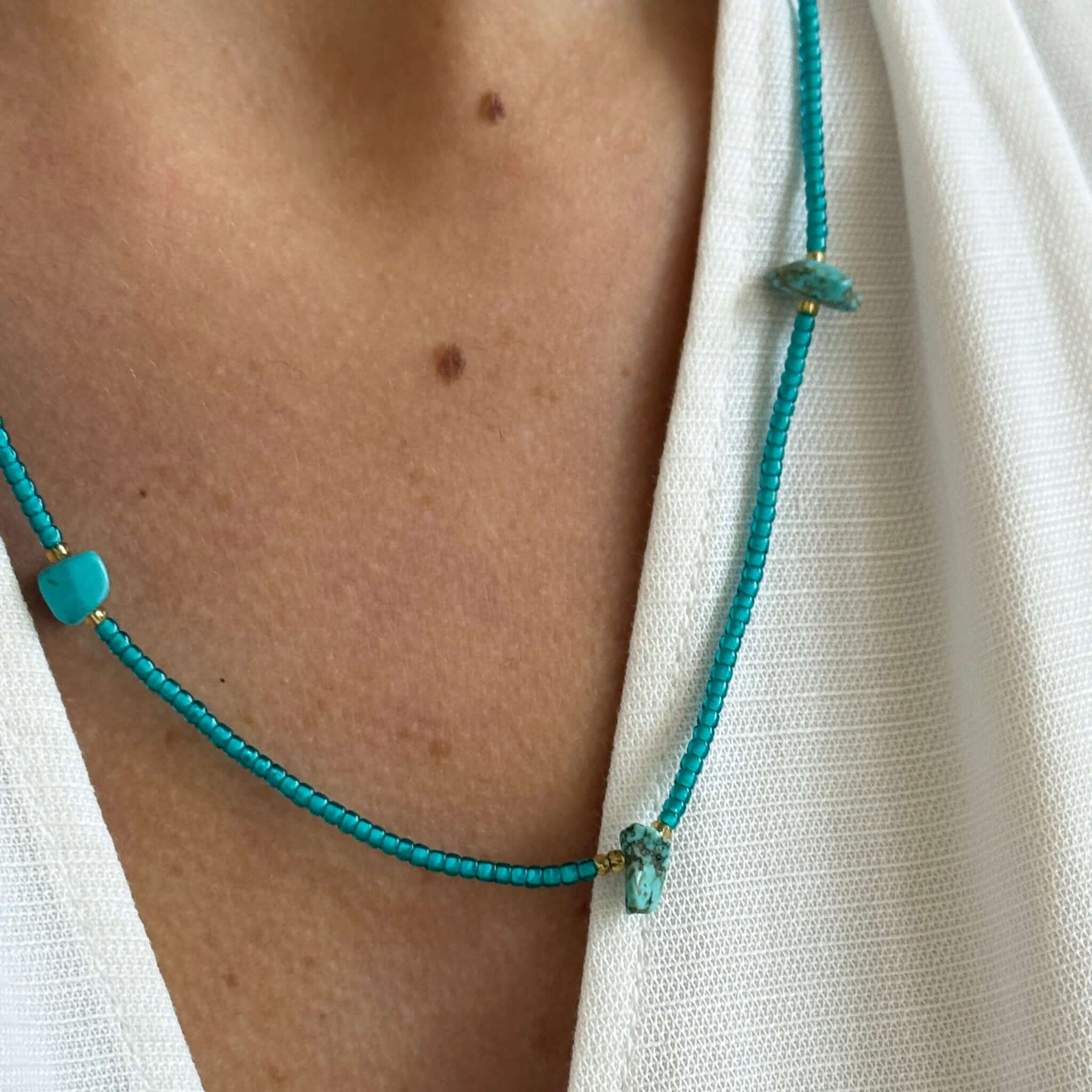 Margaret Cora Necklace featuring turquoise seed beads and raw stone accents, perfect for summer wear.