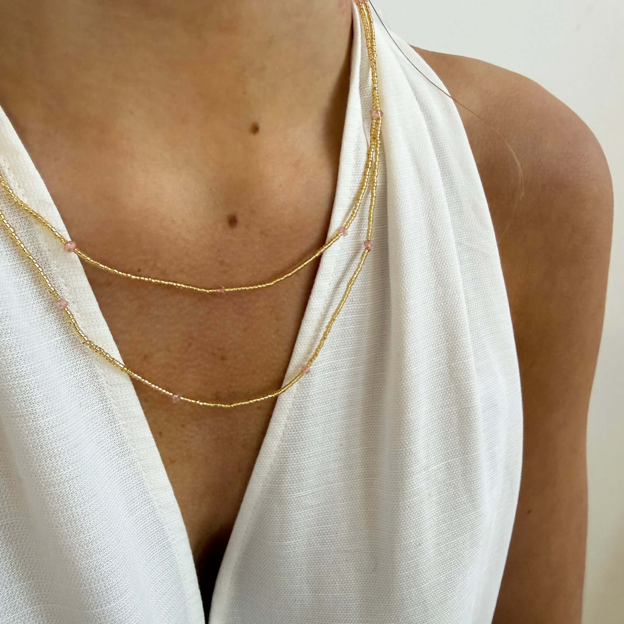 Margaret Dorothy Necklace worn by a model, showcasing its gold seed beads and delicate faceted accent beads.