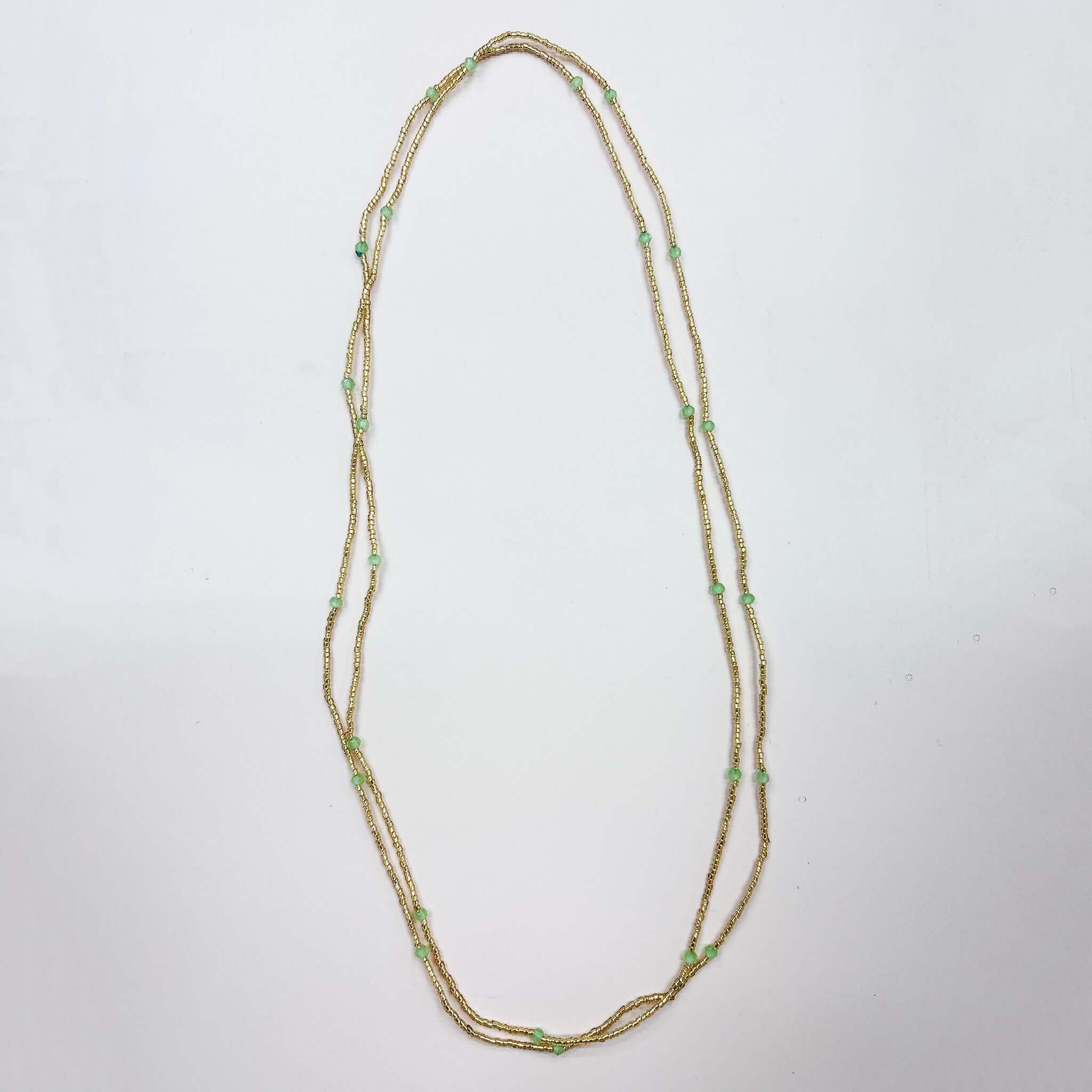 Margaret Dorothy Necklace featuring long gold seed beads and delicate faceted accent beads.