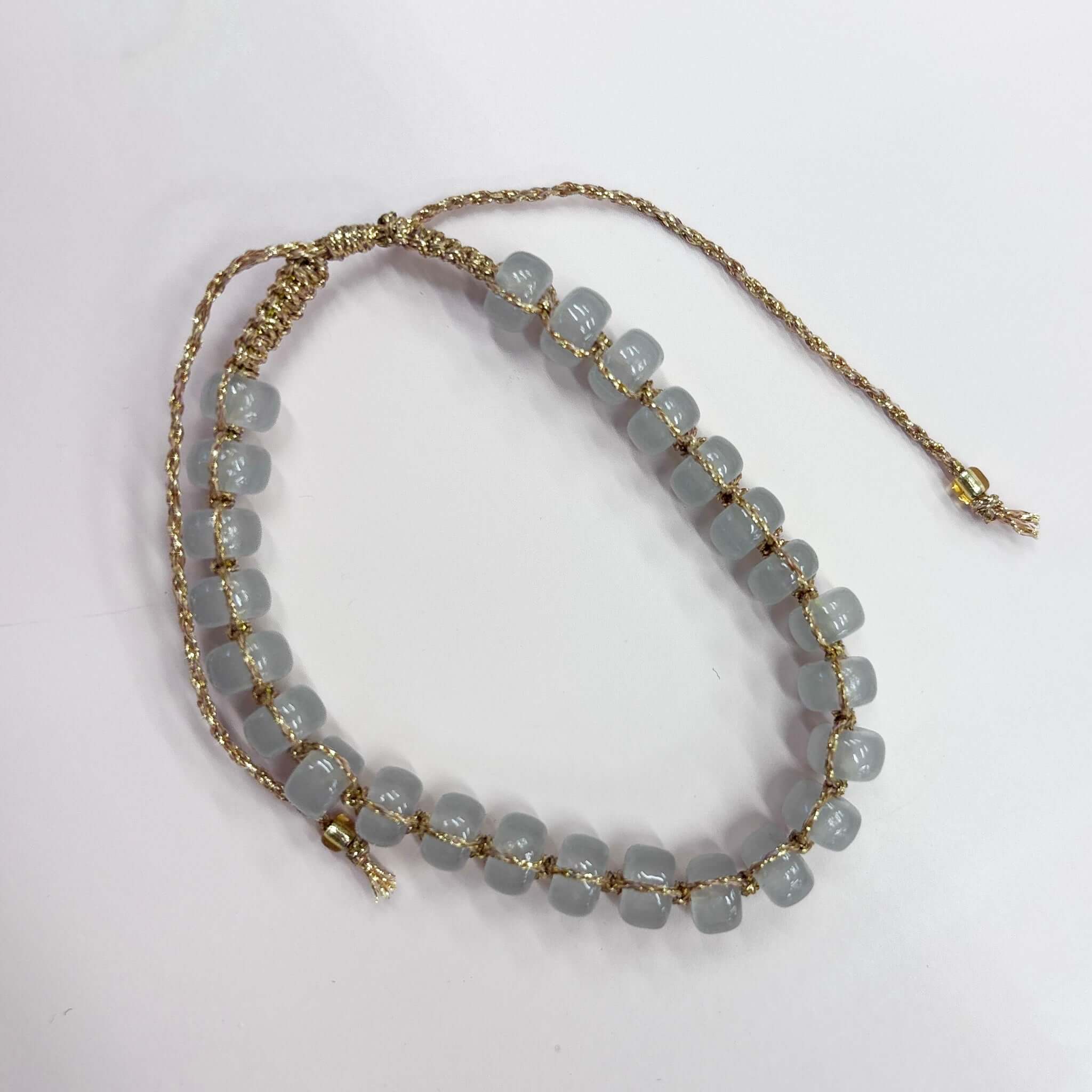 Margaret Edna Bracelet featuring chunky beads on a fine gold cord with adjustable closure, styled softly and beautifully.