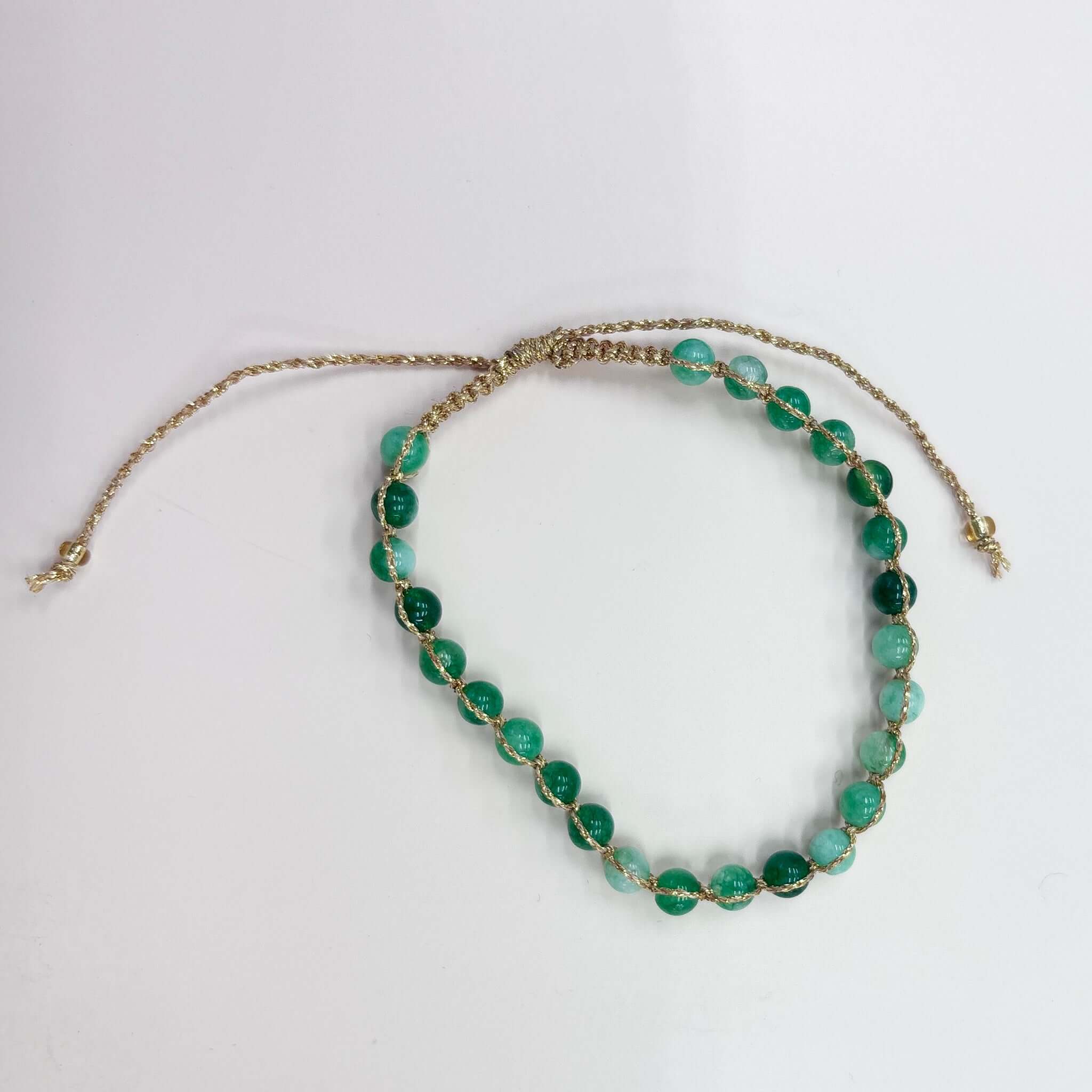 Margaret Ellen Bracelet featuring smooth, green stone beads set in delicate gold thread.