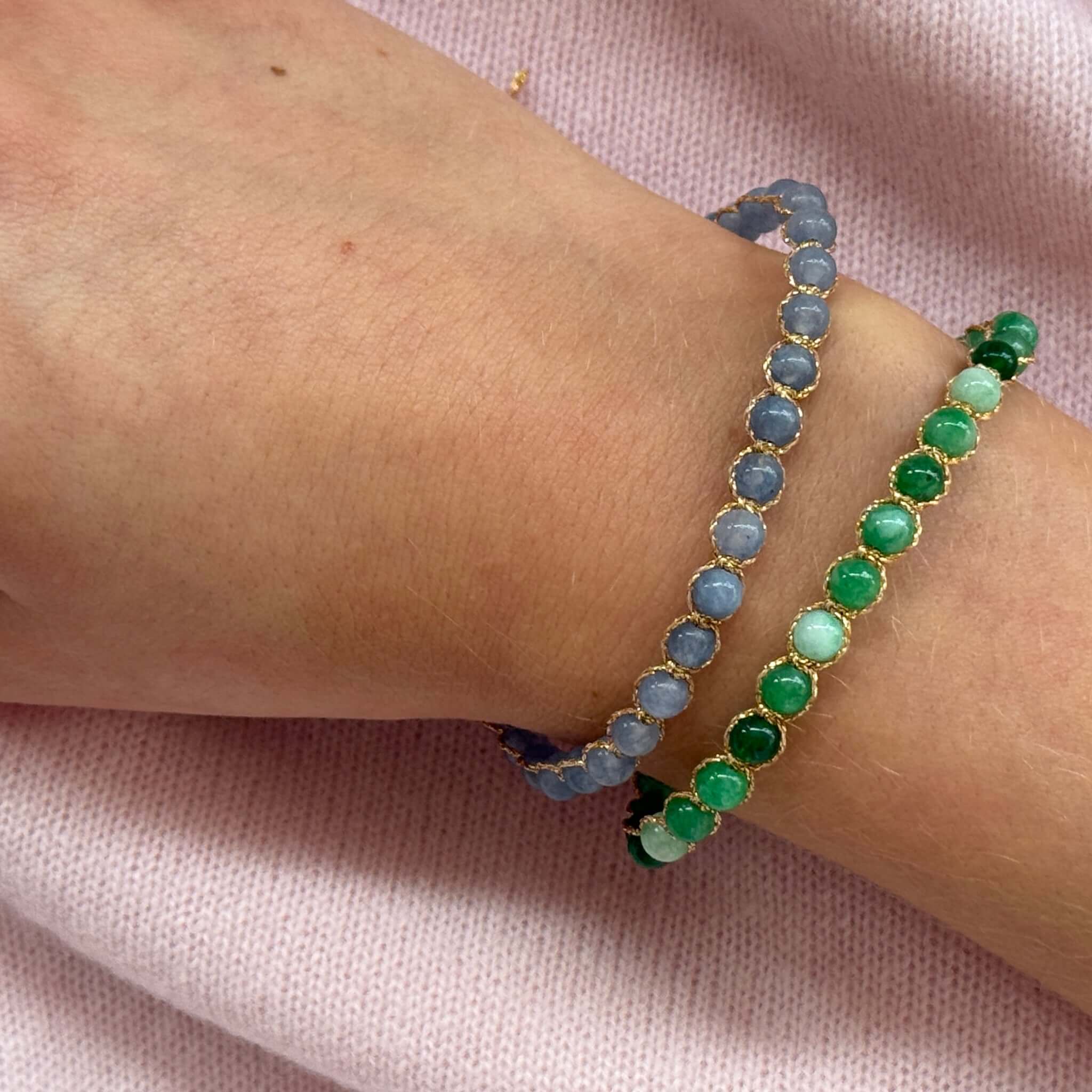 Two Margaret Ellen Bracelets stacked together featuring dusky blue and rich green stone beads on a wrist.