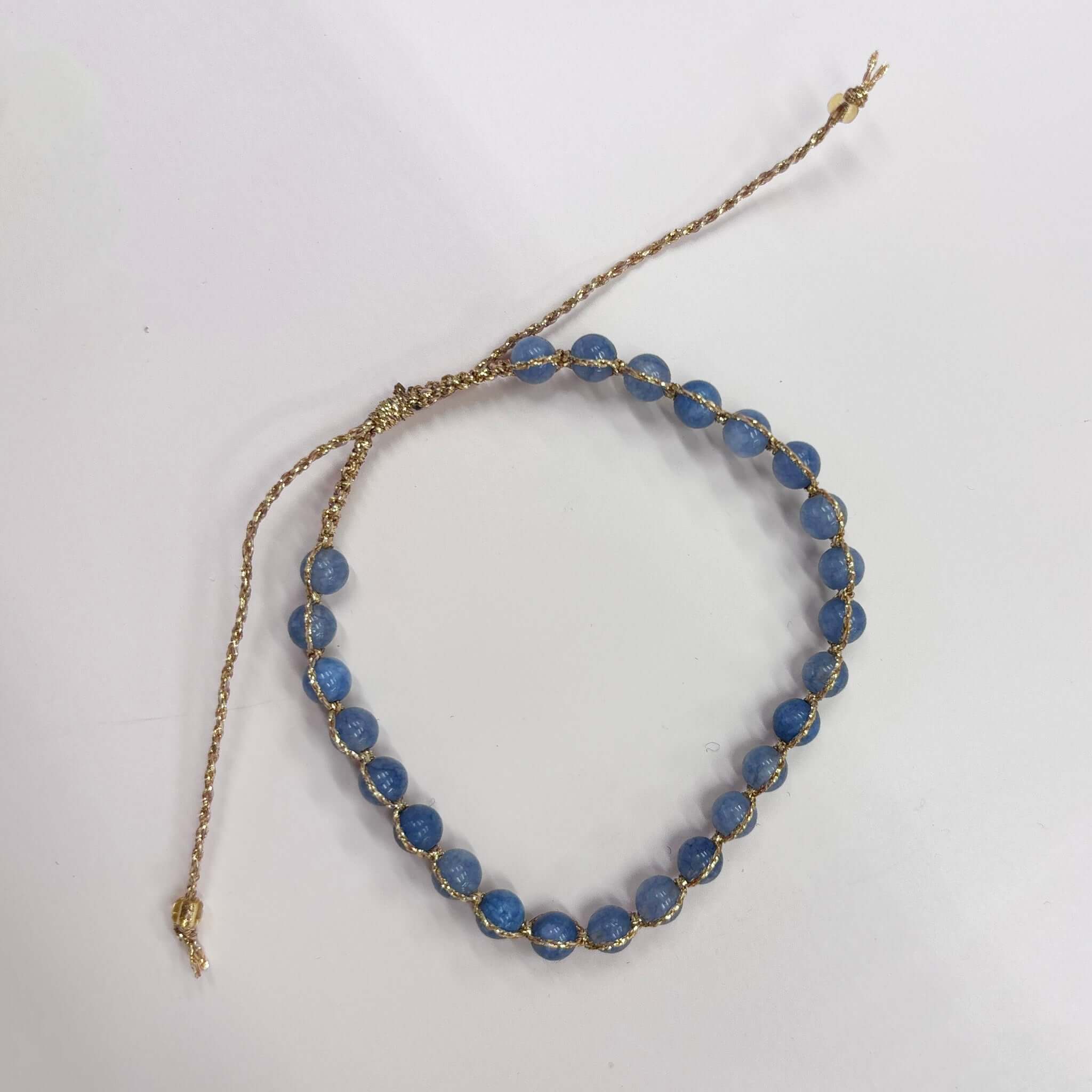 Margaret Ellen Bracelet featuring smooth, round stone beads in dusky blue with delicate gold thread.