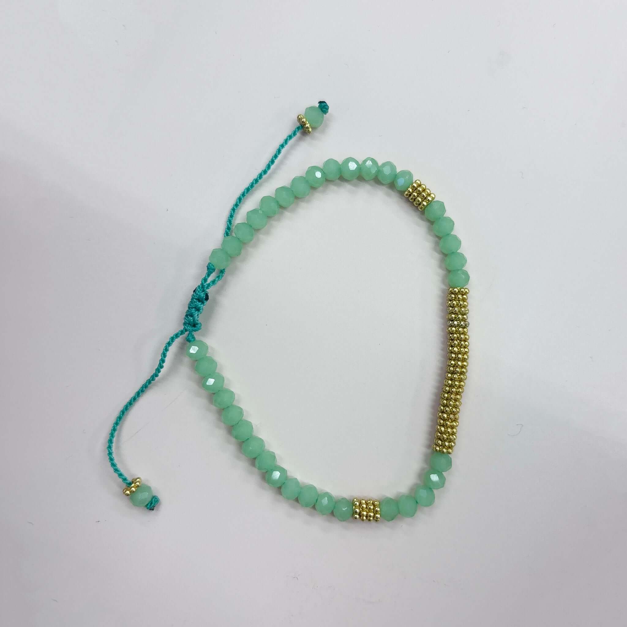Margaret Lola Bracelet featuring mint crystal beads and a woven gold bead bar centerpiece.