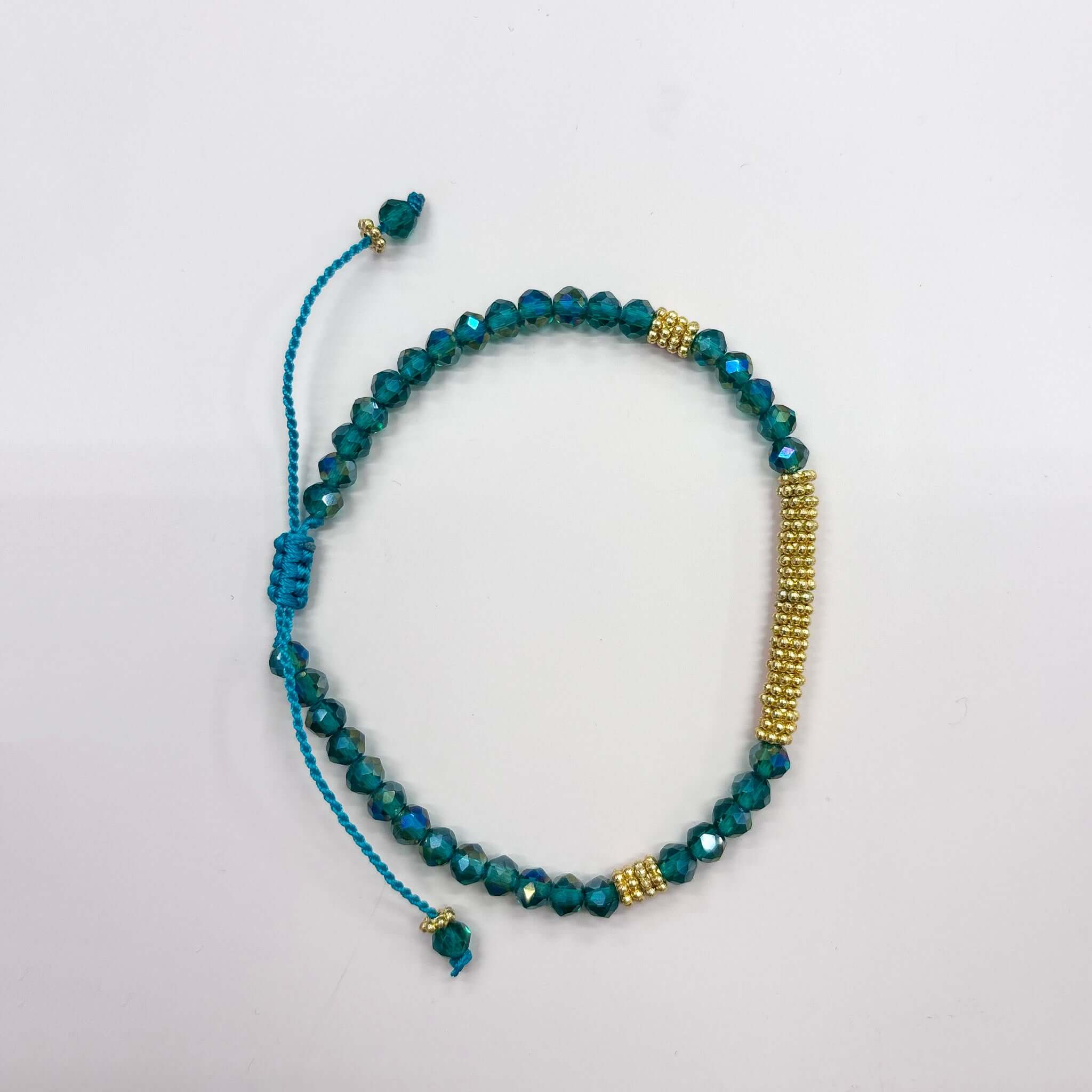 Margaret Lola Bracelet featuring crystal beads and a woven gold bead bar, with adjustable sliding cord closure.
