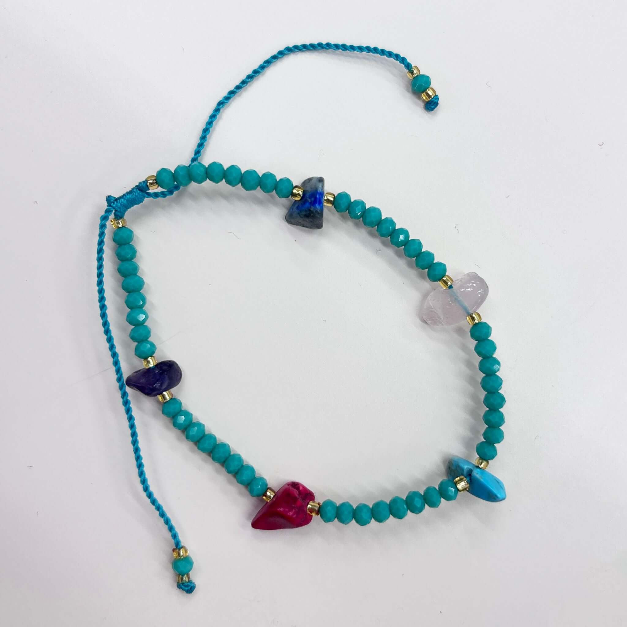 Colorful Margaret Lucille Bracelet featuring turquoise, amethyst, lapis, and red agate stones with gold spacers.