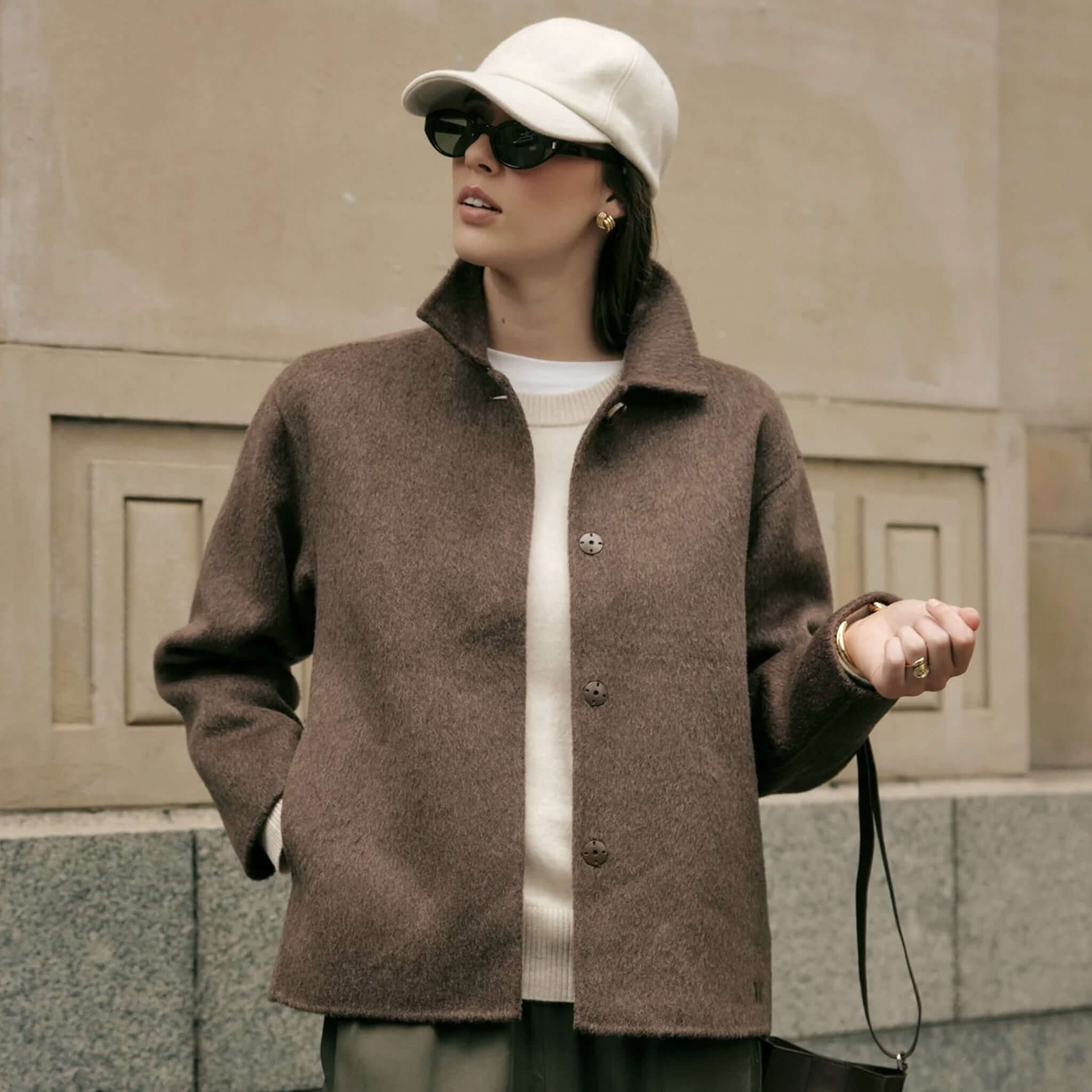 Marlow Loft Wool Coat - Mushroom worn by a woman in sunglasses and a cap, showcasing its premium wool fabric.
