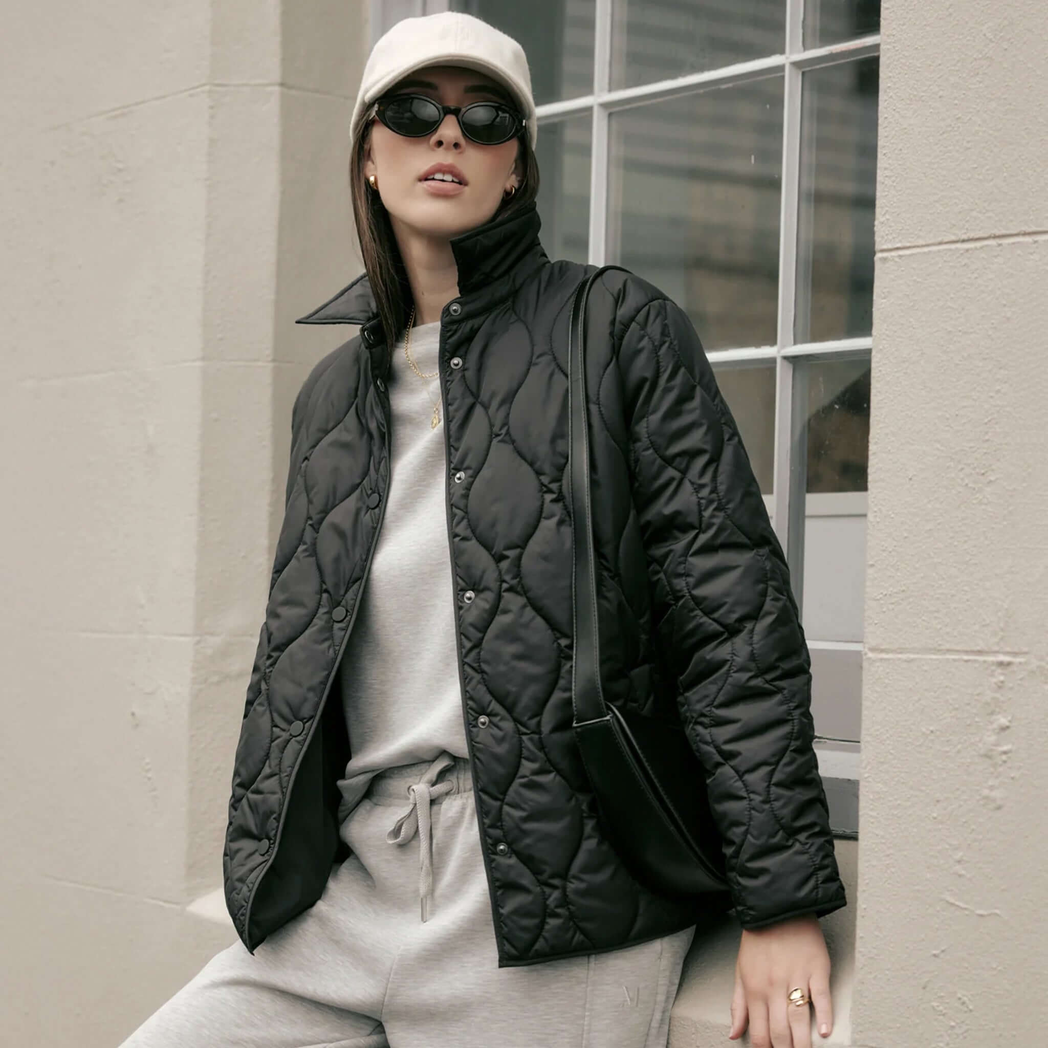 Marlow Toronto Quilted Jacket - Black worn by a model with sunglasses and a cap.