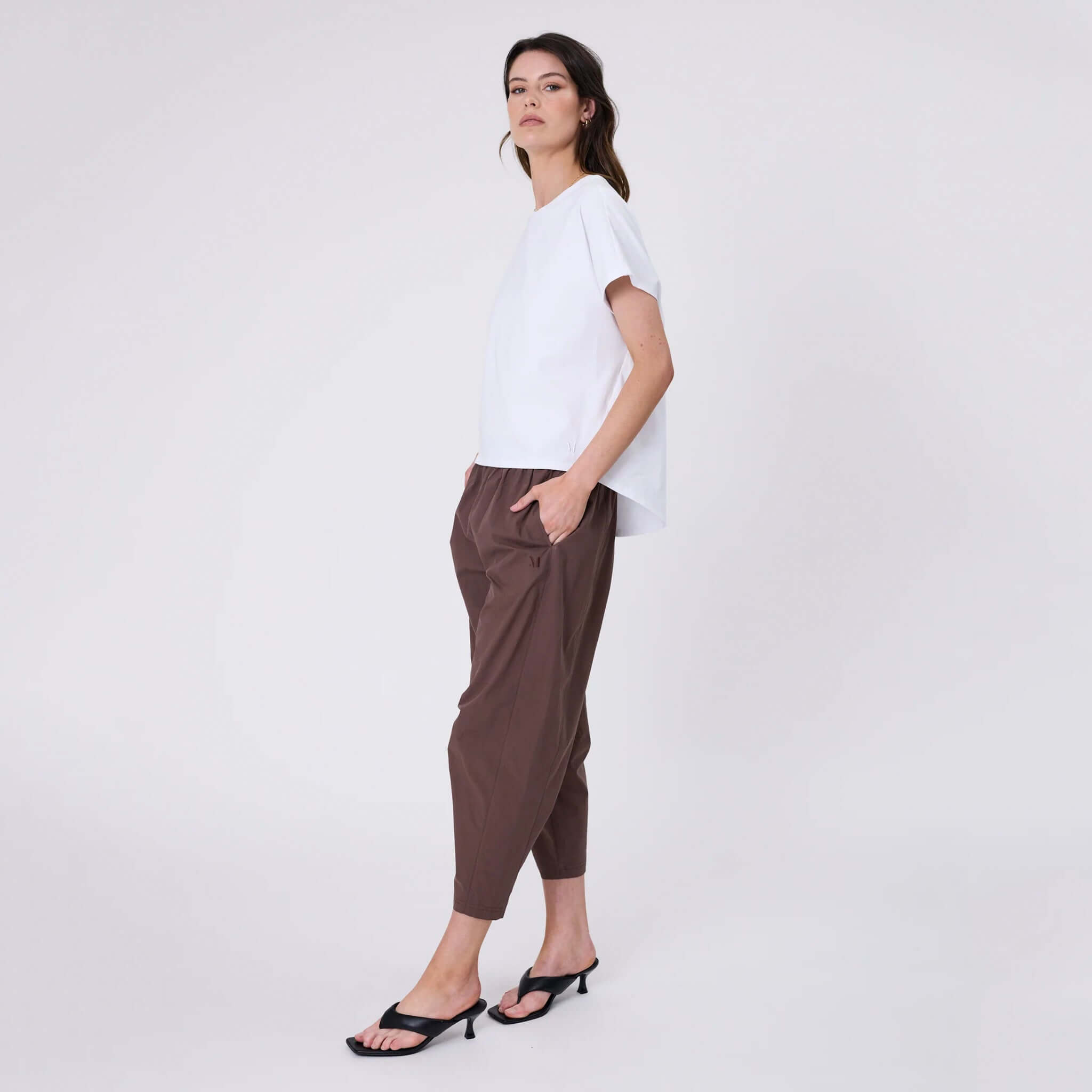 Marlow Barrel Tee - White styled with relaxed brown pants and sandals, showcasing a contemporary casual look.