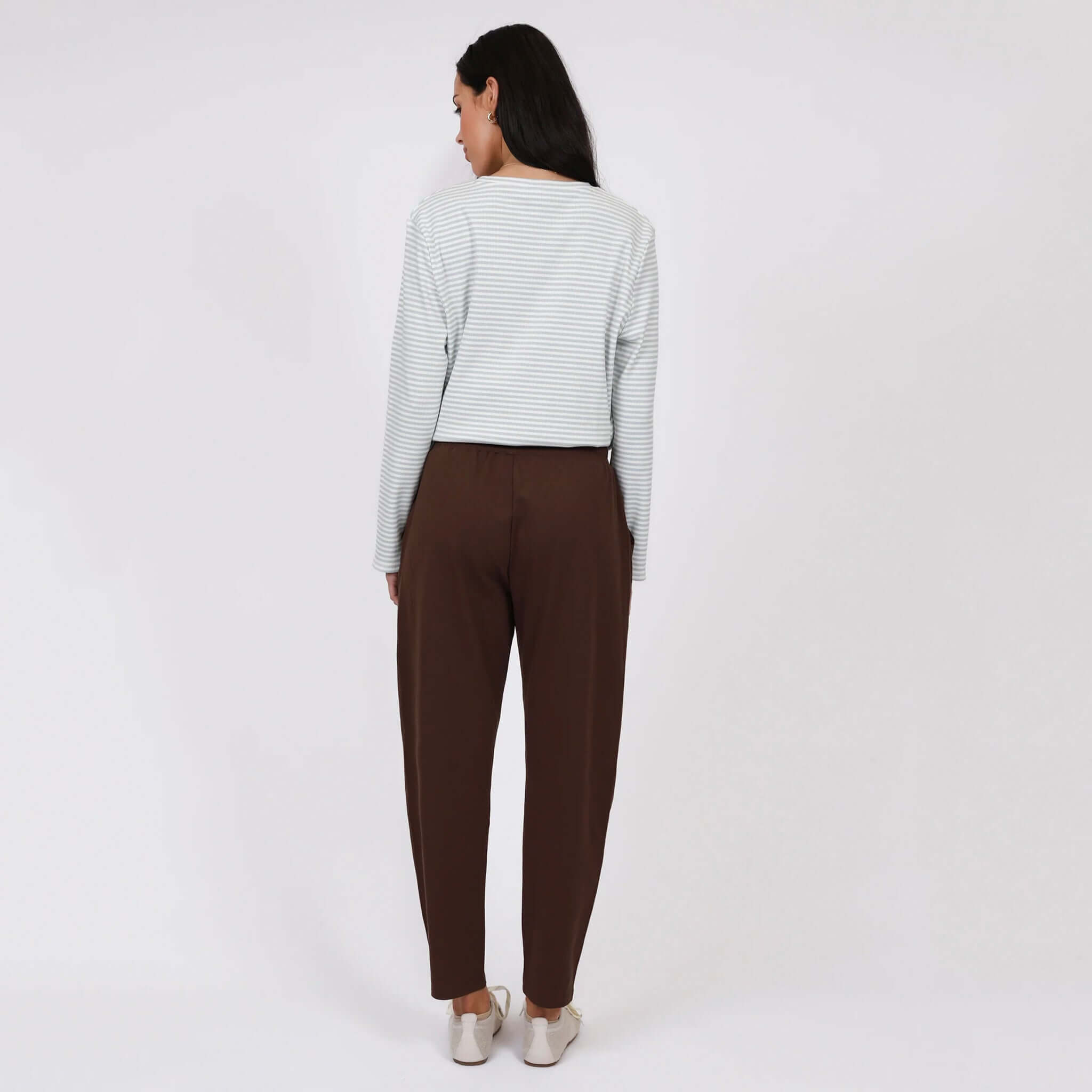 Woman wearing Marlow Barrel Trackie - Java, showcasing relaxed silhouette and stylish details from the back.