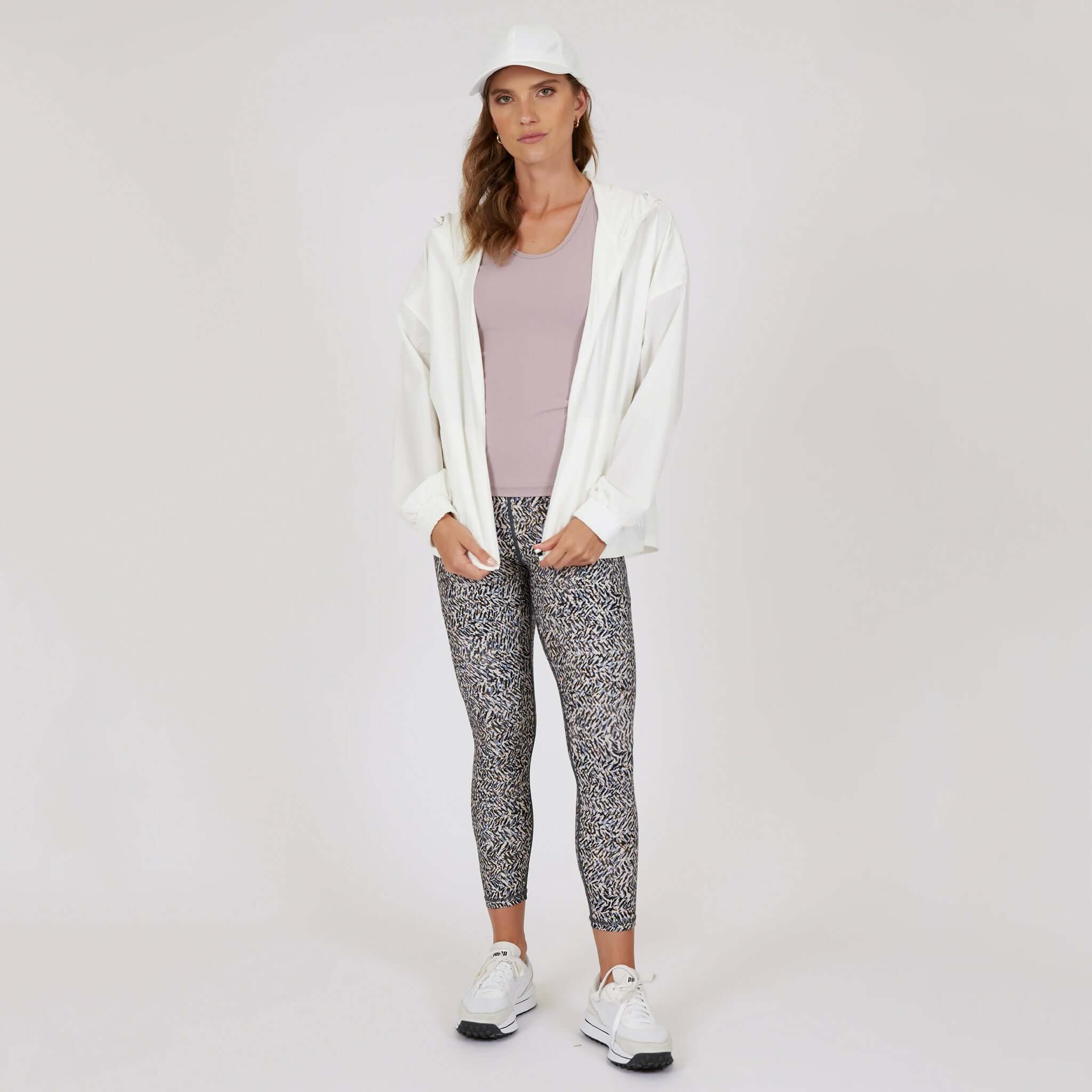 Marlow Contour Air Tank - Rose Beige styled with white jacket and patterned leggings for a chic active look.