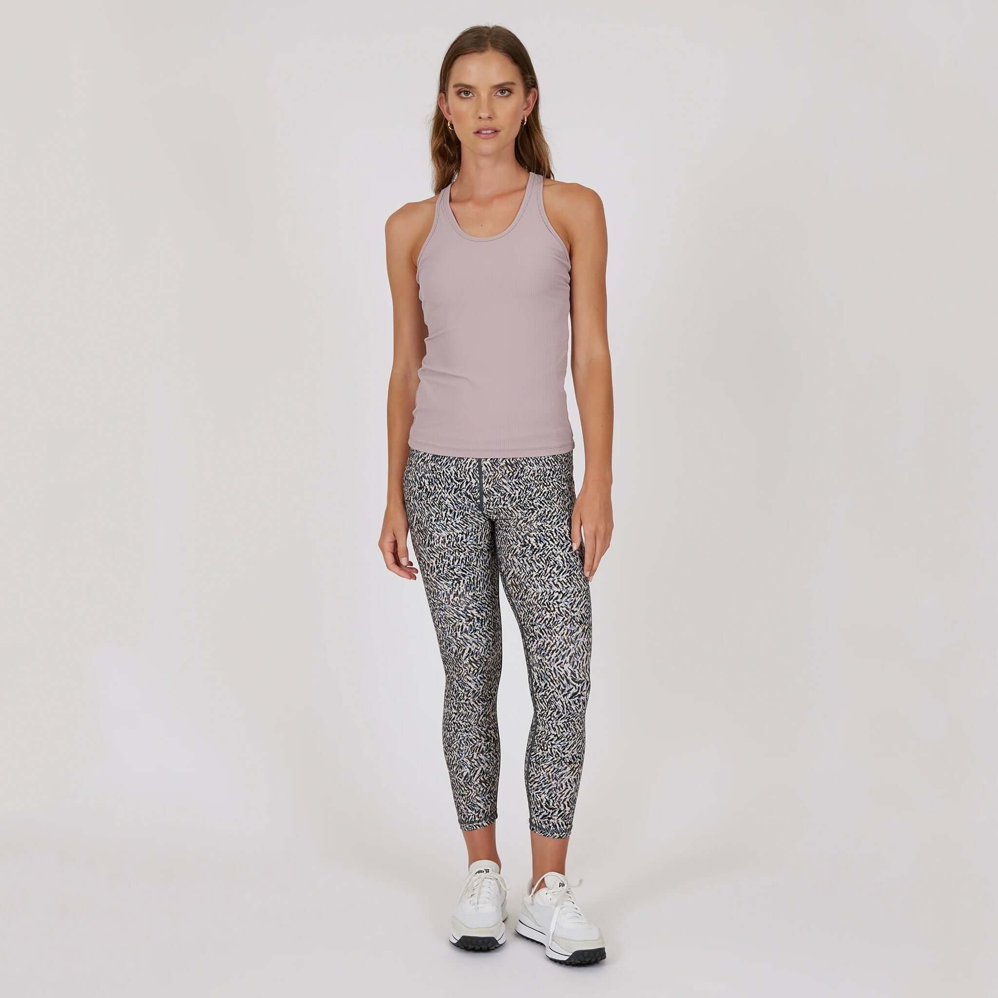 Marlow Contour Air Tank - Rose Beige worn with patterned leggings, showcasing a stylish gym-to-everything look.