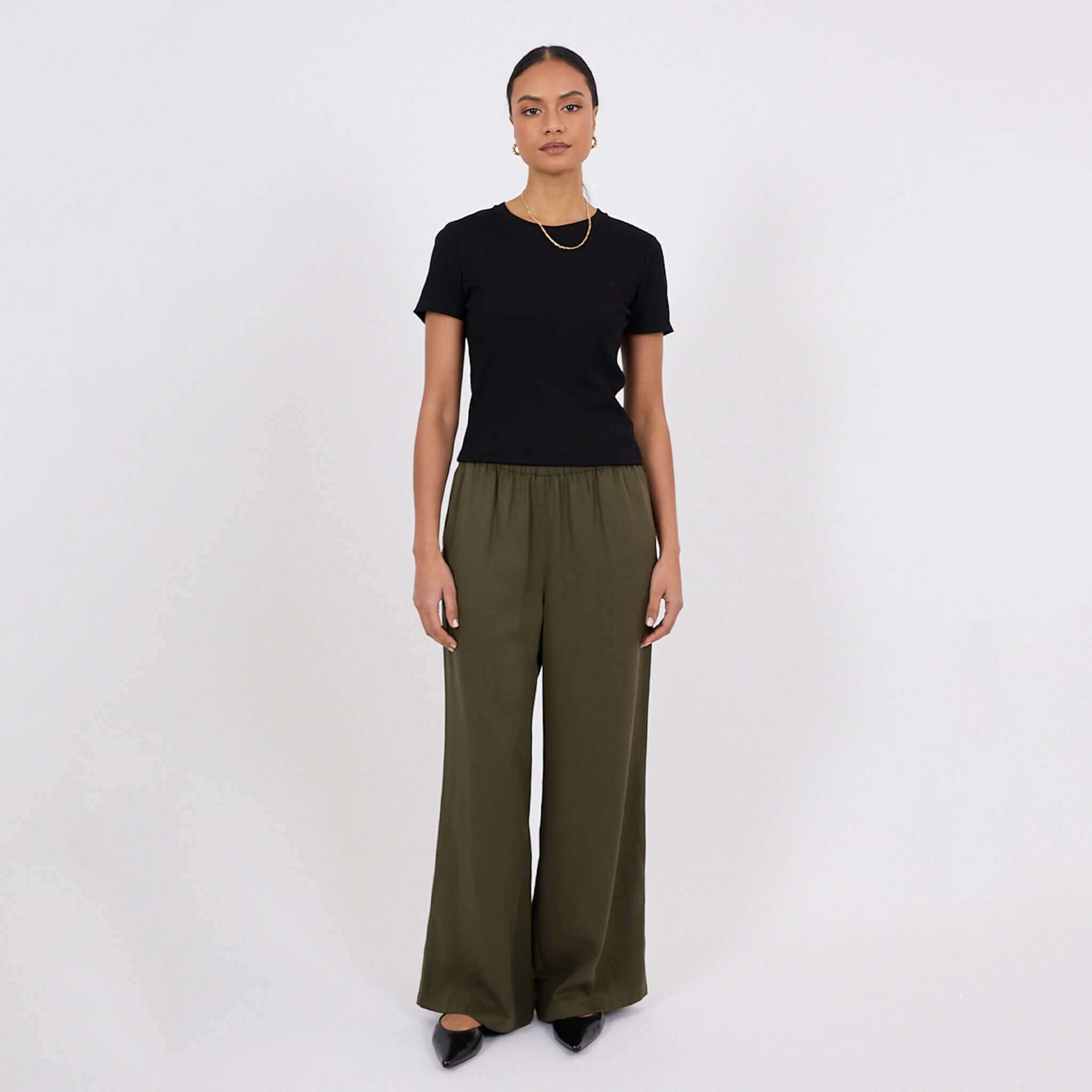 Model wearing Marlow Eclipse Wide Leg Pants - Spruce with a black top, showcasing a chic and comfortable outfit.