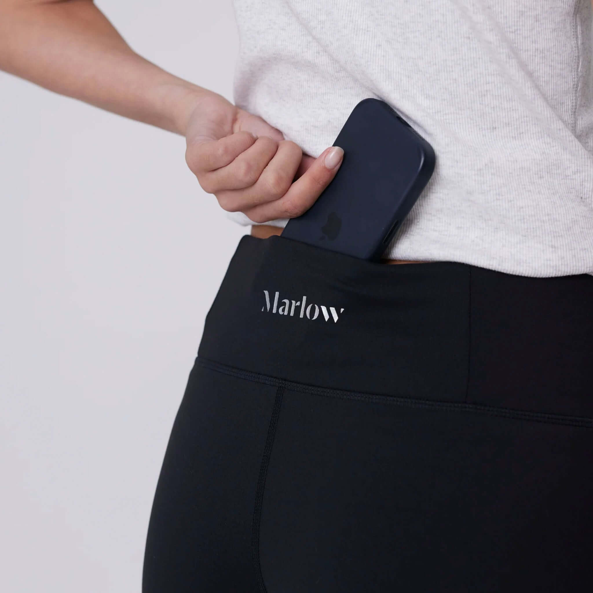 Alt Tag: Marlow Recharge Wide Leg Pants - Black with high-rise waistband and side pocket holding phone, Airbrush Sculpt fabric