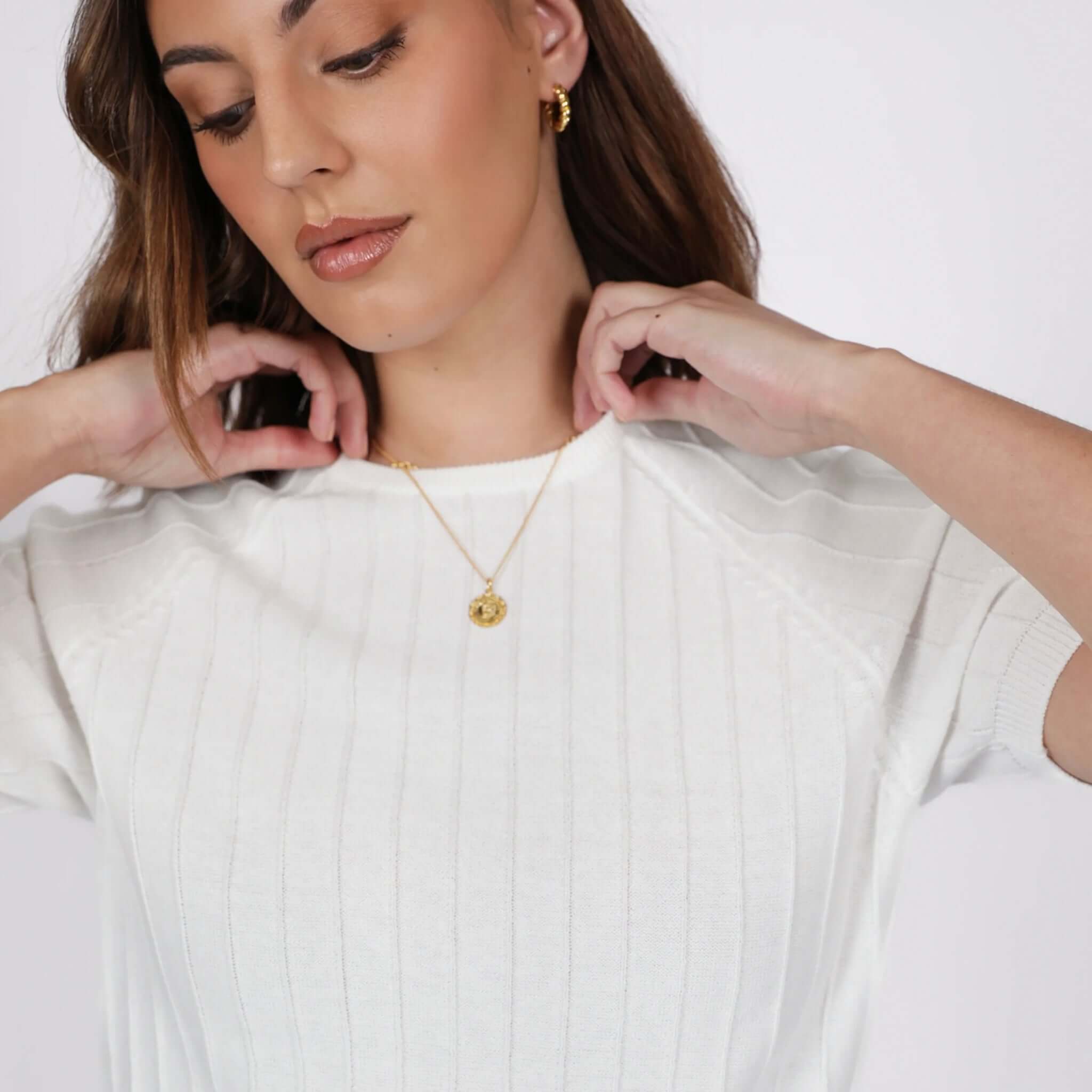Marlow Soleil Knit Tee - Ivory worn by a model, showcasing its texture and relaxed fit with gold accessories.