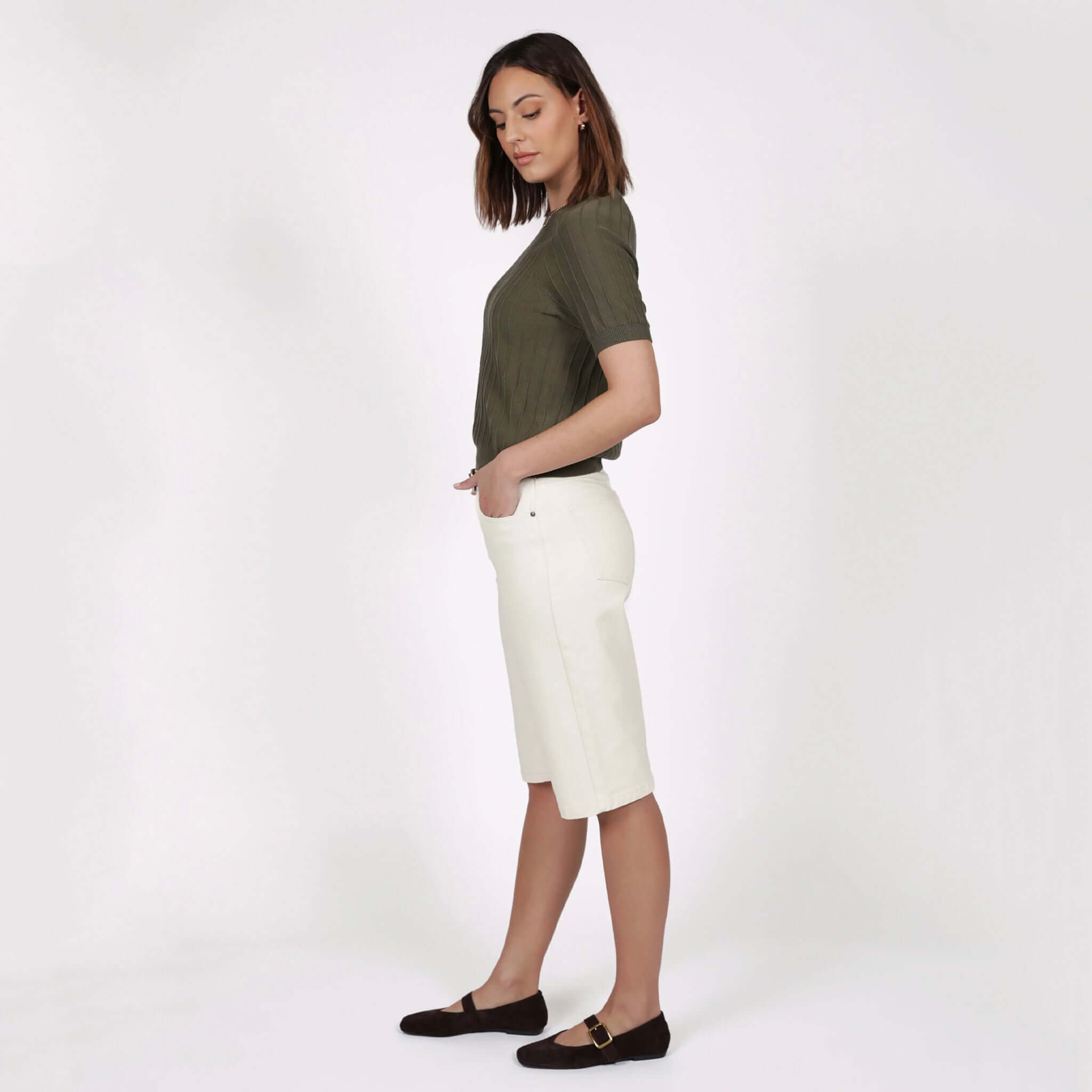 Model wearing Marlow Soleil Knit Tee - Olive with white shorts, showcasing a relaxed fit and stylish texture.