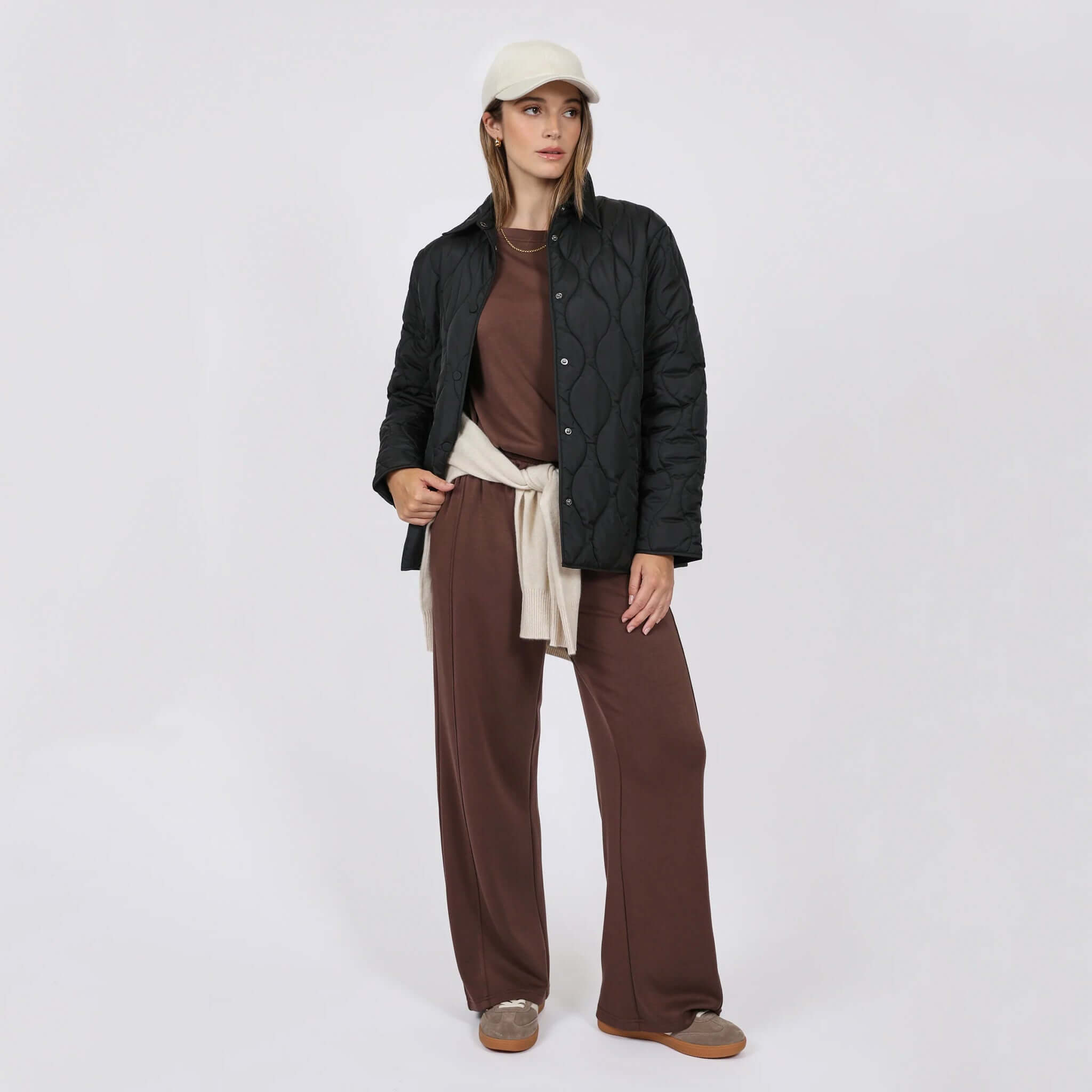 Marlow Toronto Quilted Jacket - Black worn by model with brown outfit and cap.