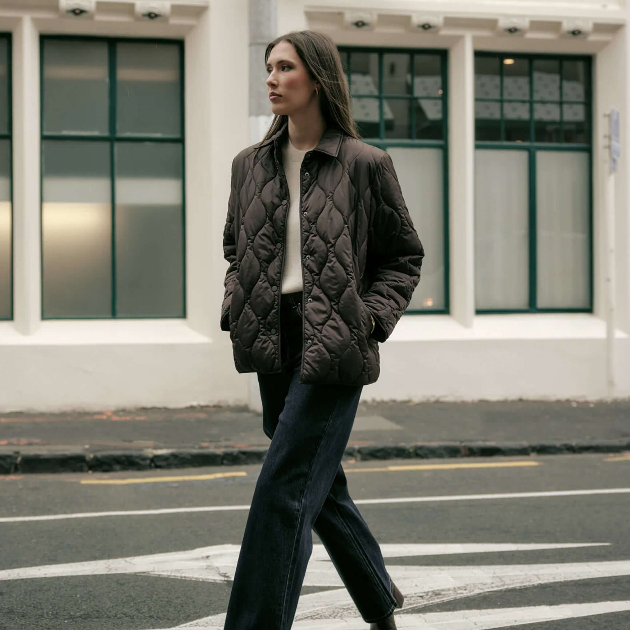 Marlow Toronto Quilted Jacket - Java worn by a woman while walking on the street.