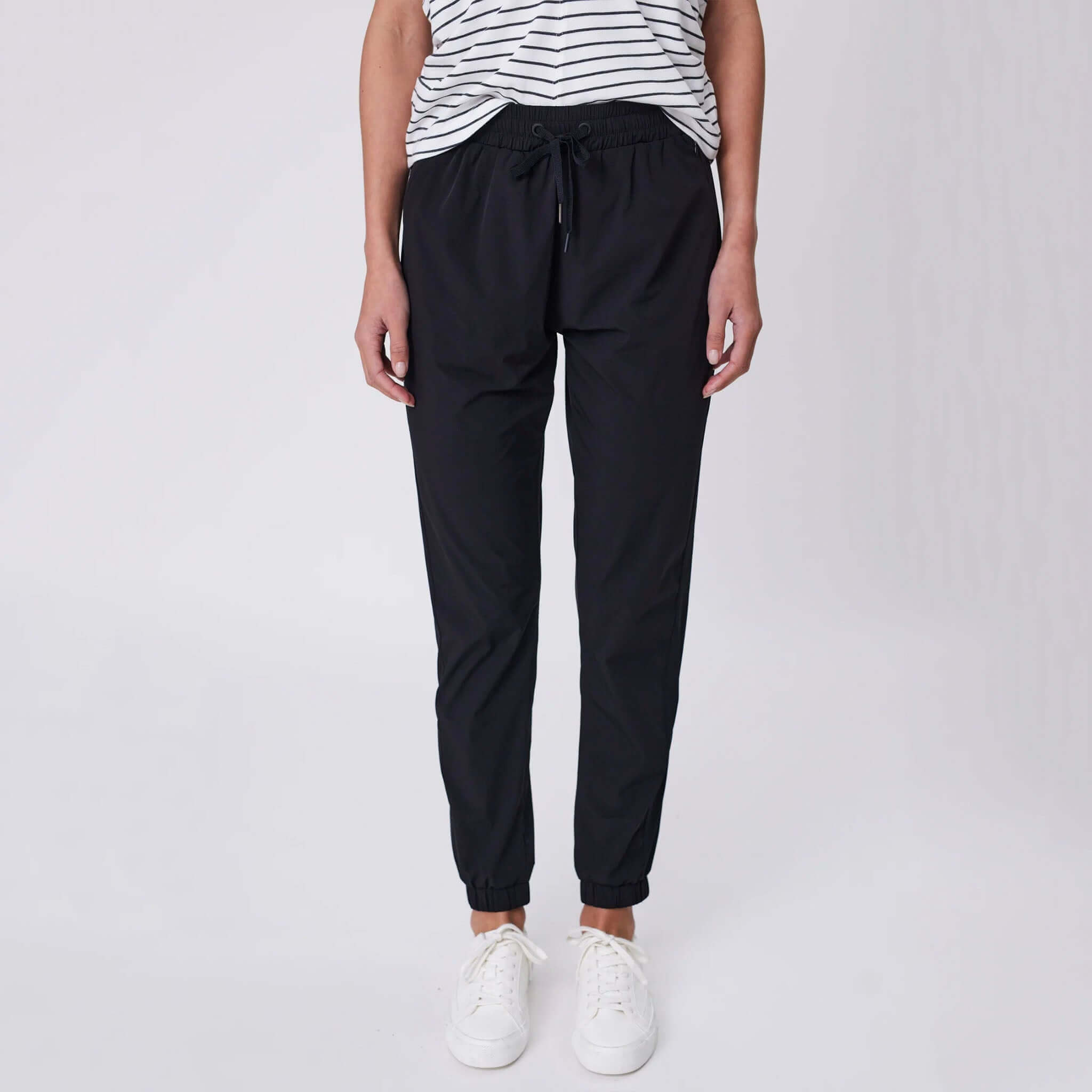 Marlow Travel Pants - Black tapered leg travel pants with elasticated drawstring waist and zip pockets, front view