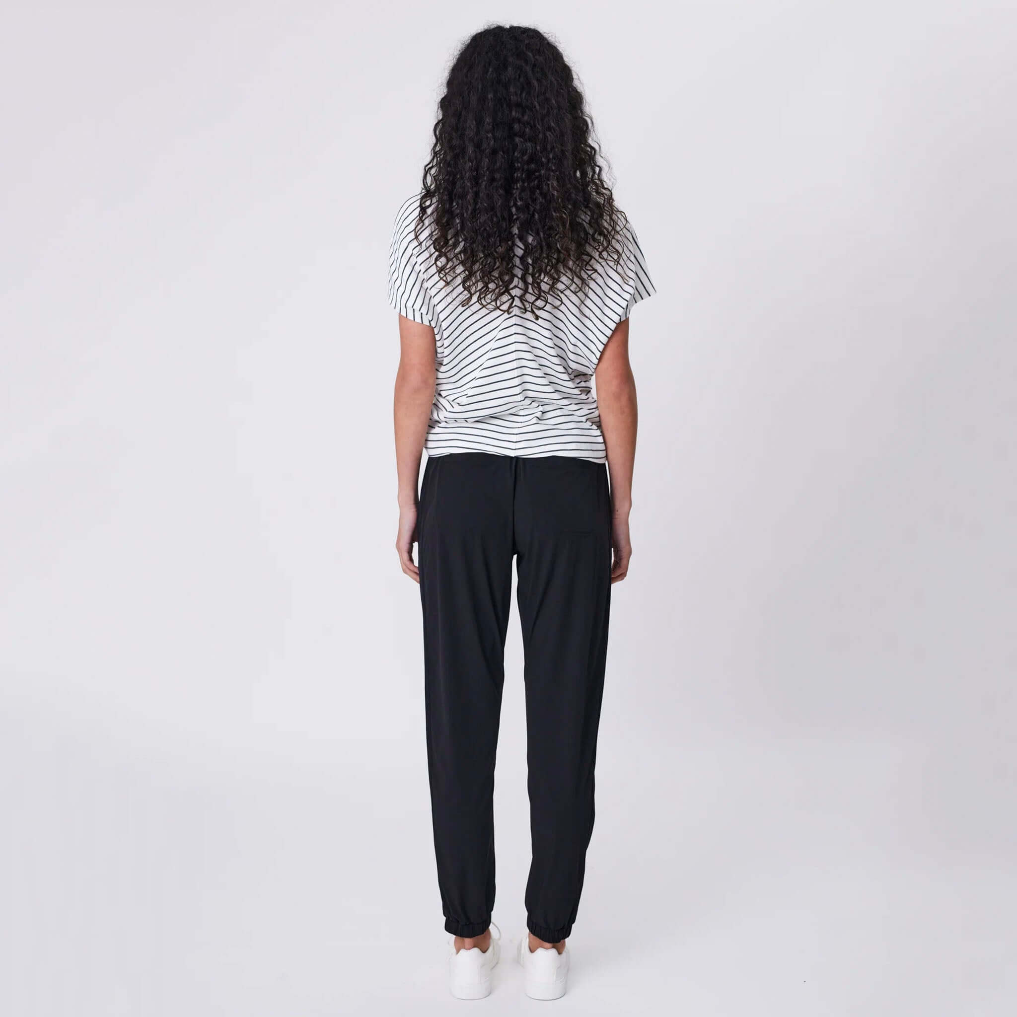 Alt Tag: Marlow Travel Pants - Black rear view on model, tapered leg featherlight stretch travel pants with elastic drawstring waist