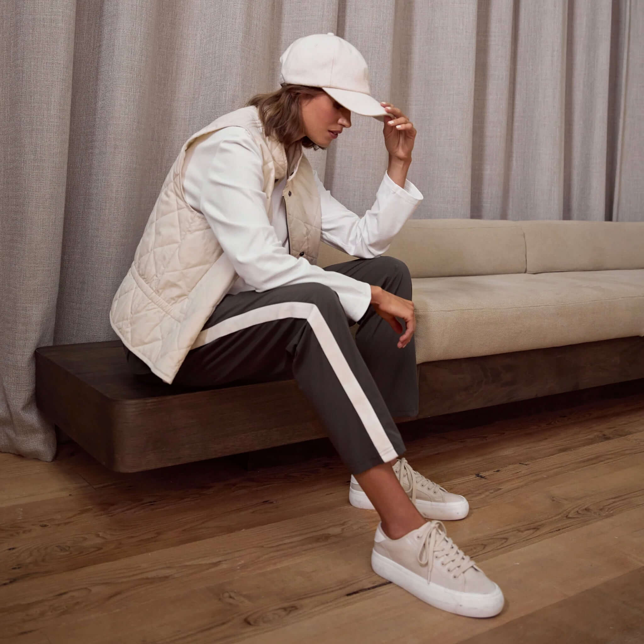 Alt Tag: Marlow Wool Cap in ivory wool blend on model with adjustable strap, classic 6-panel women’s winter cap