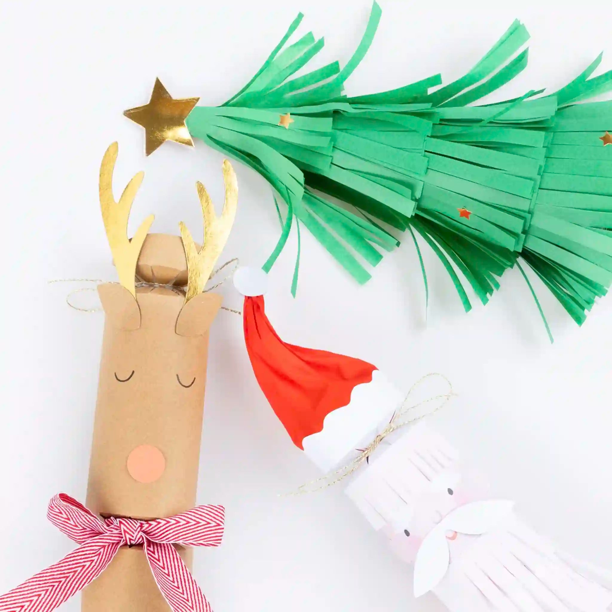 Paper reindeer craft with green antlers and red nose on a white background