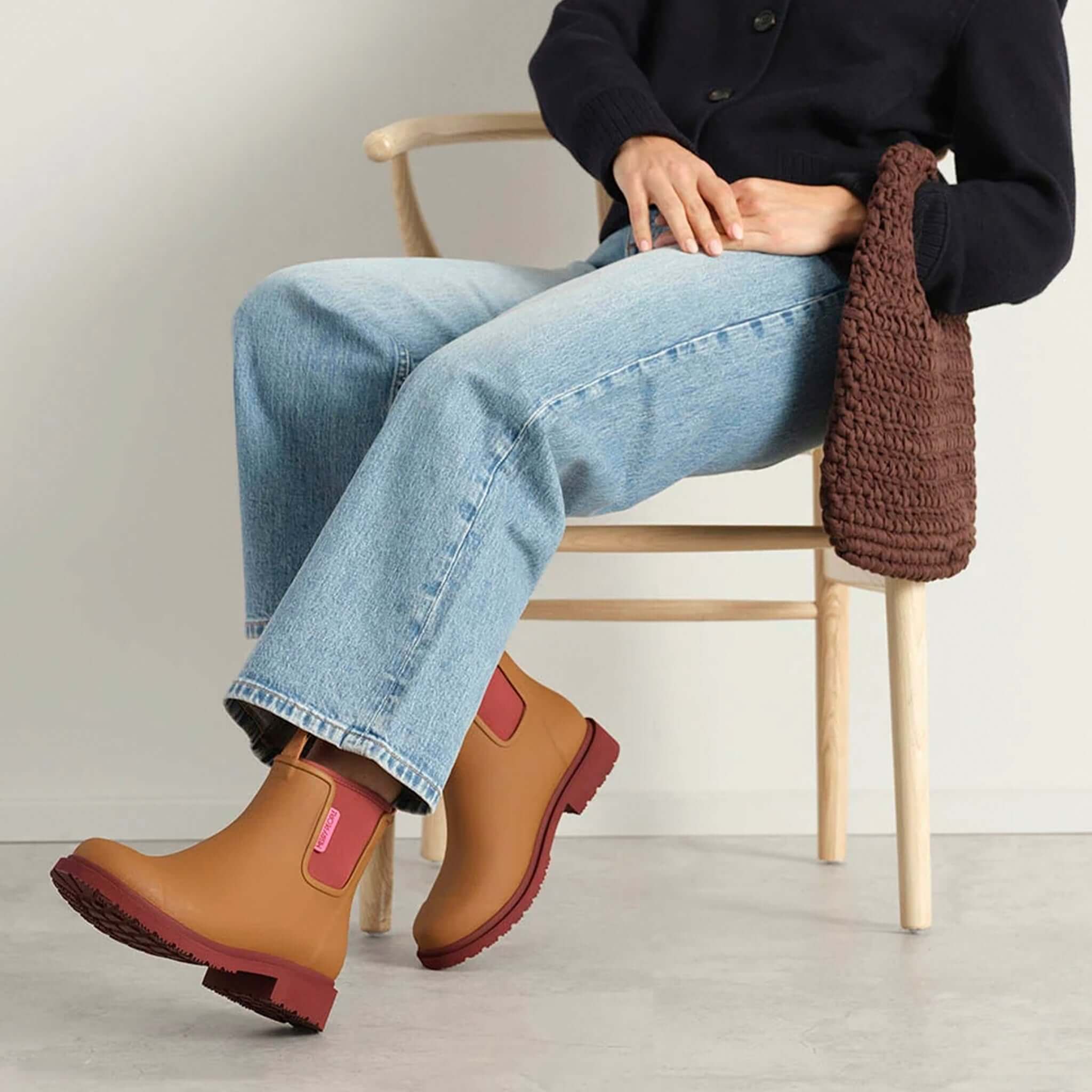 Merry People Bobbi Ankle Boots - Ochre showcased with denim jeans sitting on a chair.