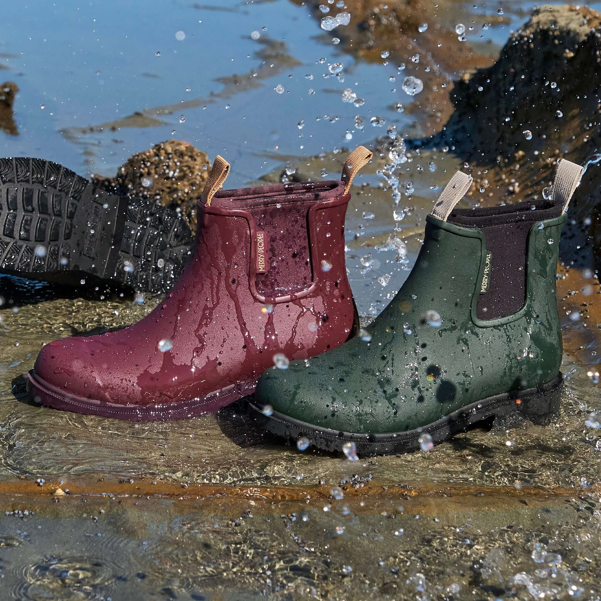 Merry People Bobbi Ankle Boots - Dark Cherry splashing in water, showcasing waterproof features and stylish design.