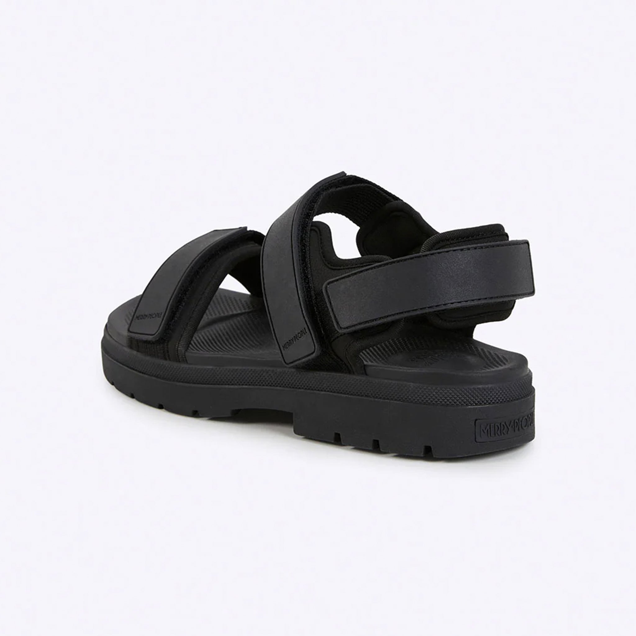 Black sandal with multiple straps on a light gray background