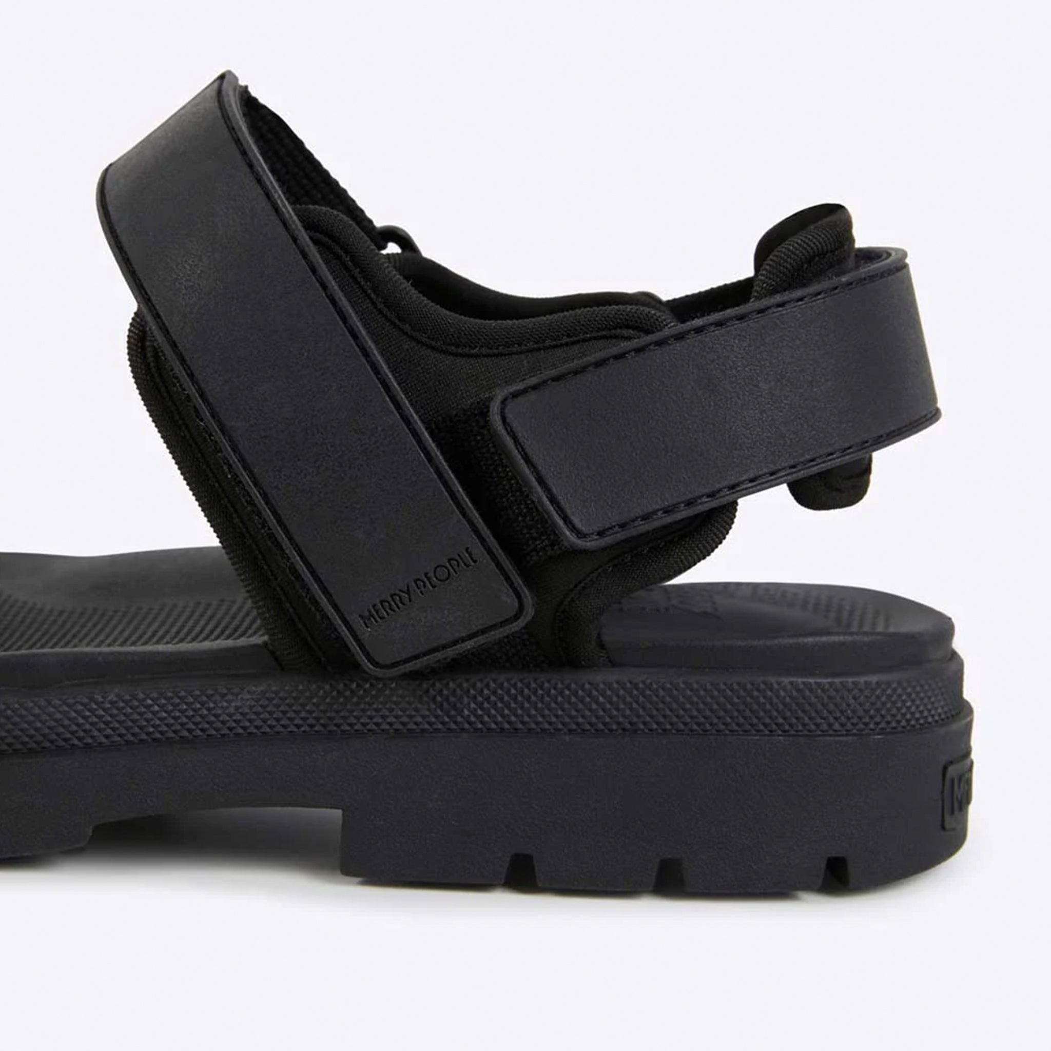 Black sandal with strap design on a white background