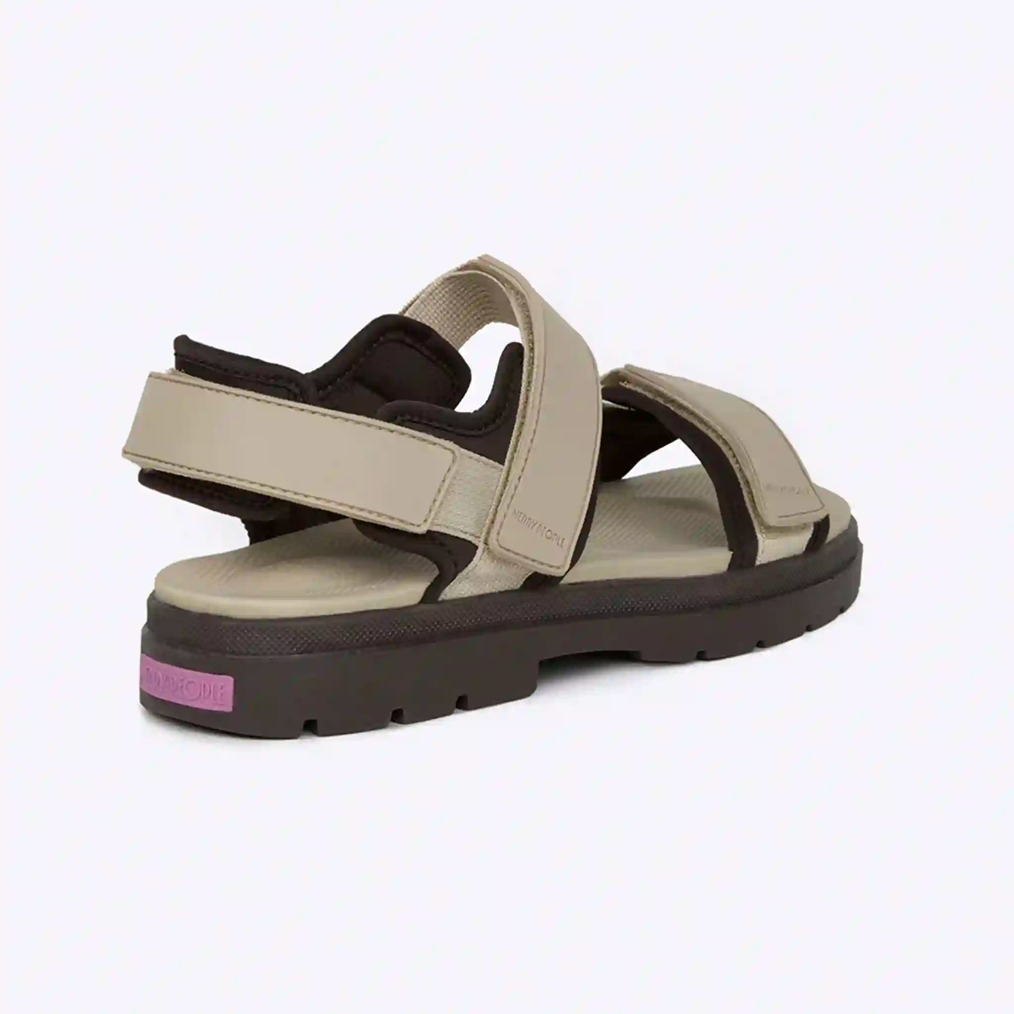 Beige sandal with black sole on a white background